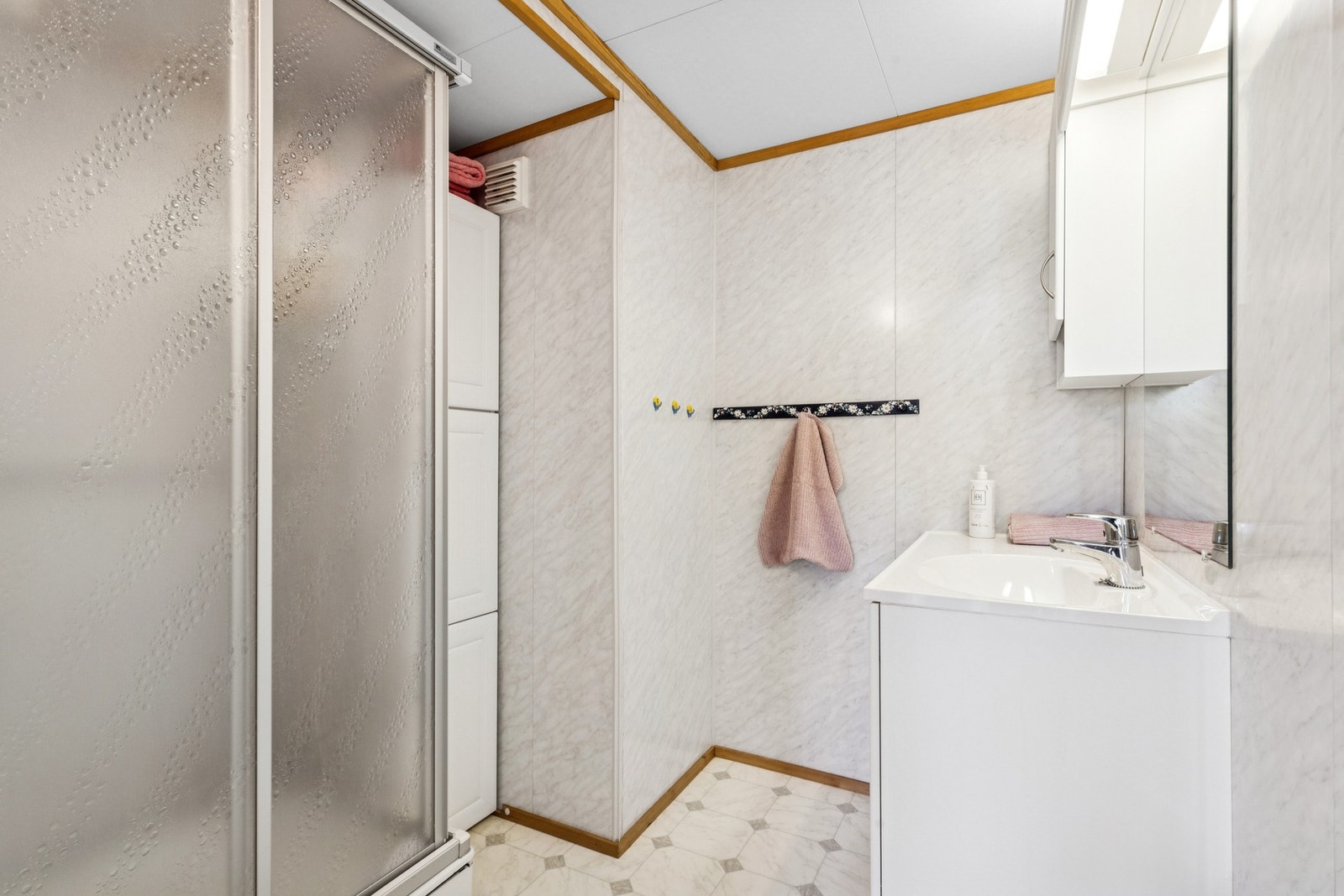 Baderommet er innredet med servant, speil og dusjkabinett. Galleribilde