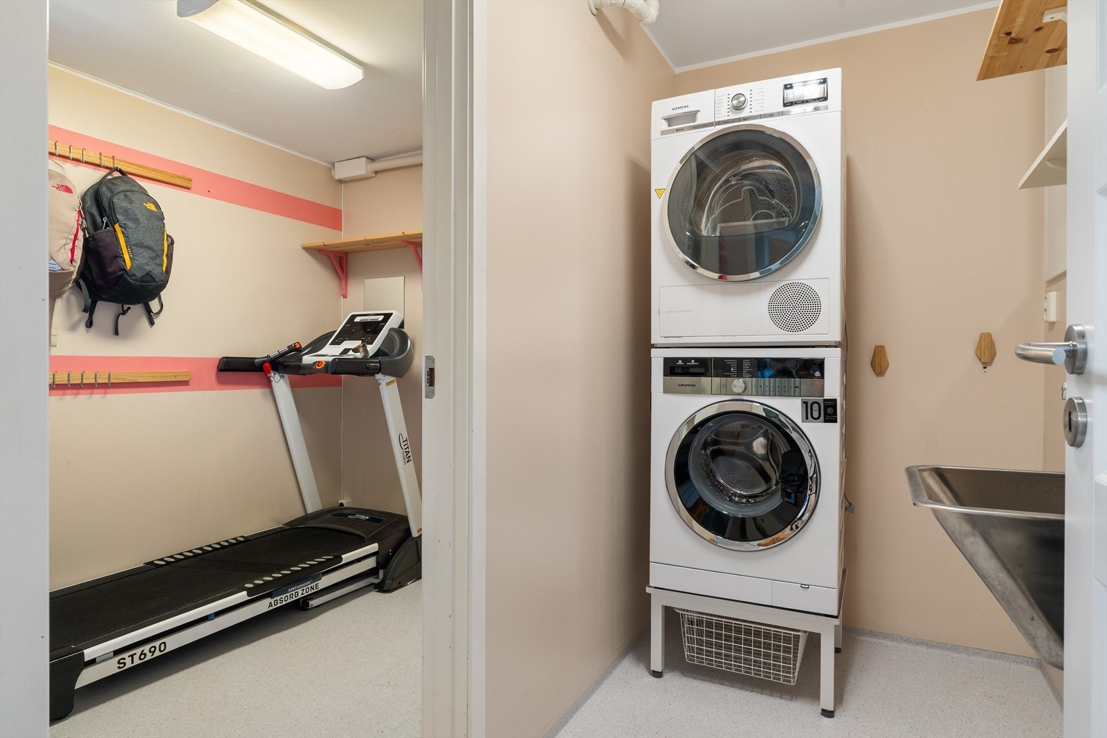 Boligen har også et eget vaskerom på 3,8m² med opplegg for vaskemaskin og tørketrommel. Her er det også inngang til stor sportsbod på 5,4m² som idag brukes som treningsrom. Galleribilde