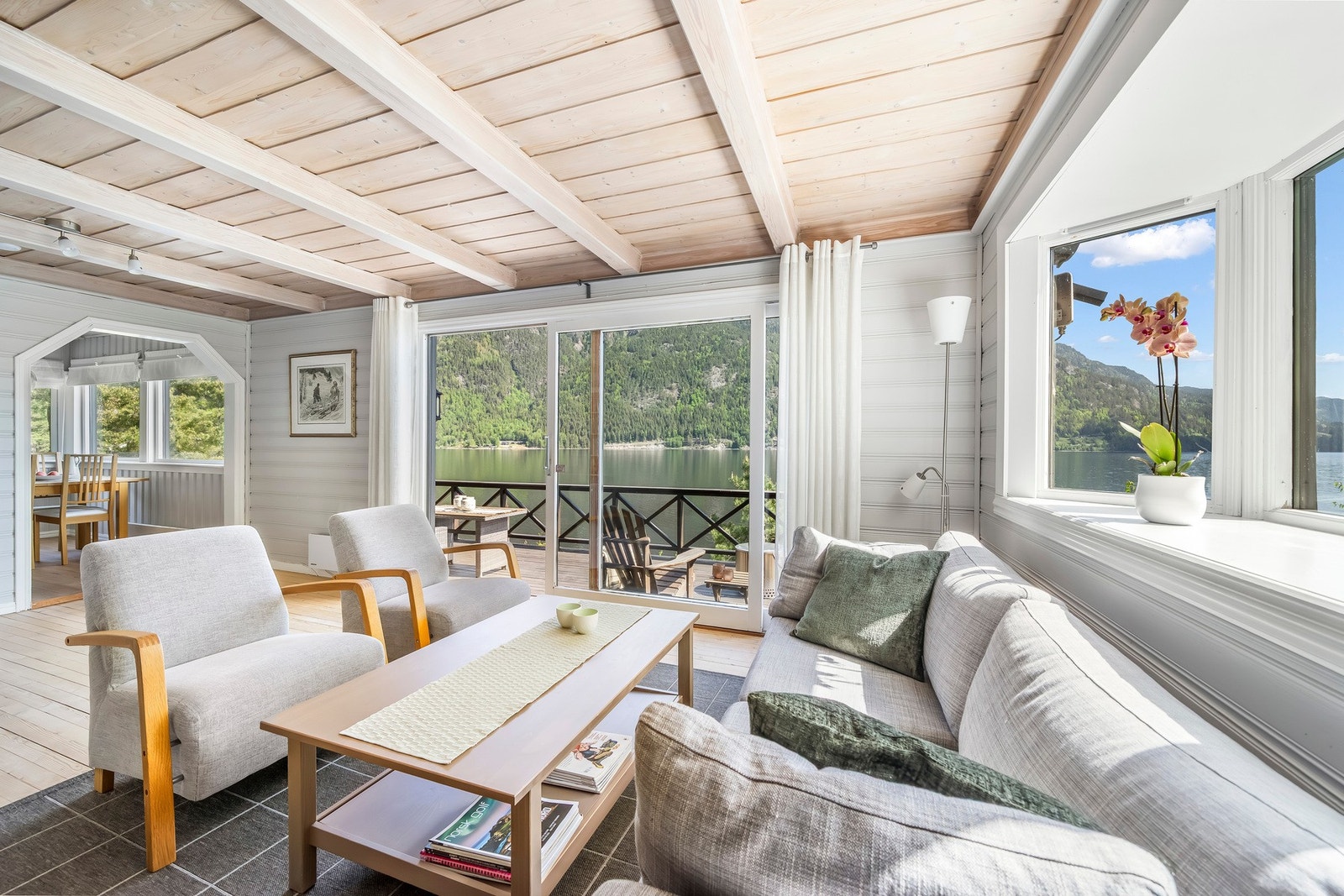 Stuen er lys med store skyvedører ut på verandaen. Galleribilde