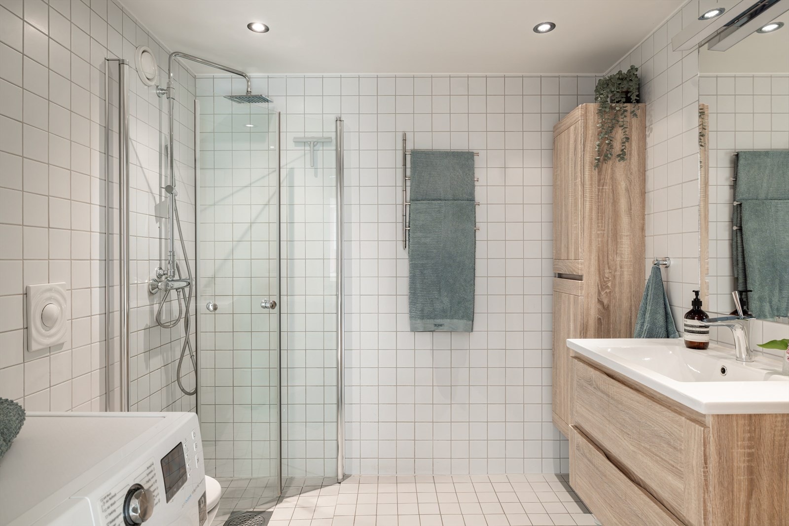 Romslig og meget pent flislagt baderom med varmekabler i gulv. Opplegg for både vaskemaskin og tørketrommel. Innfellbare glassdører gir optimal romutnyttelse, nye i 2014 Galleribilde