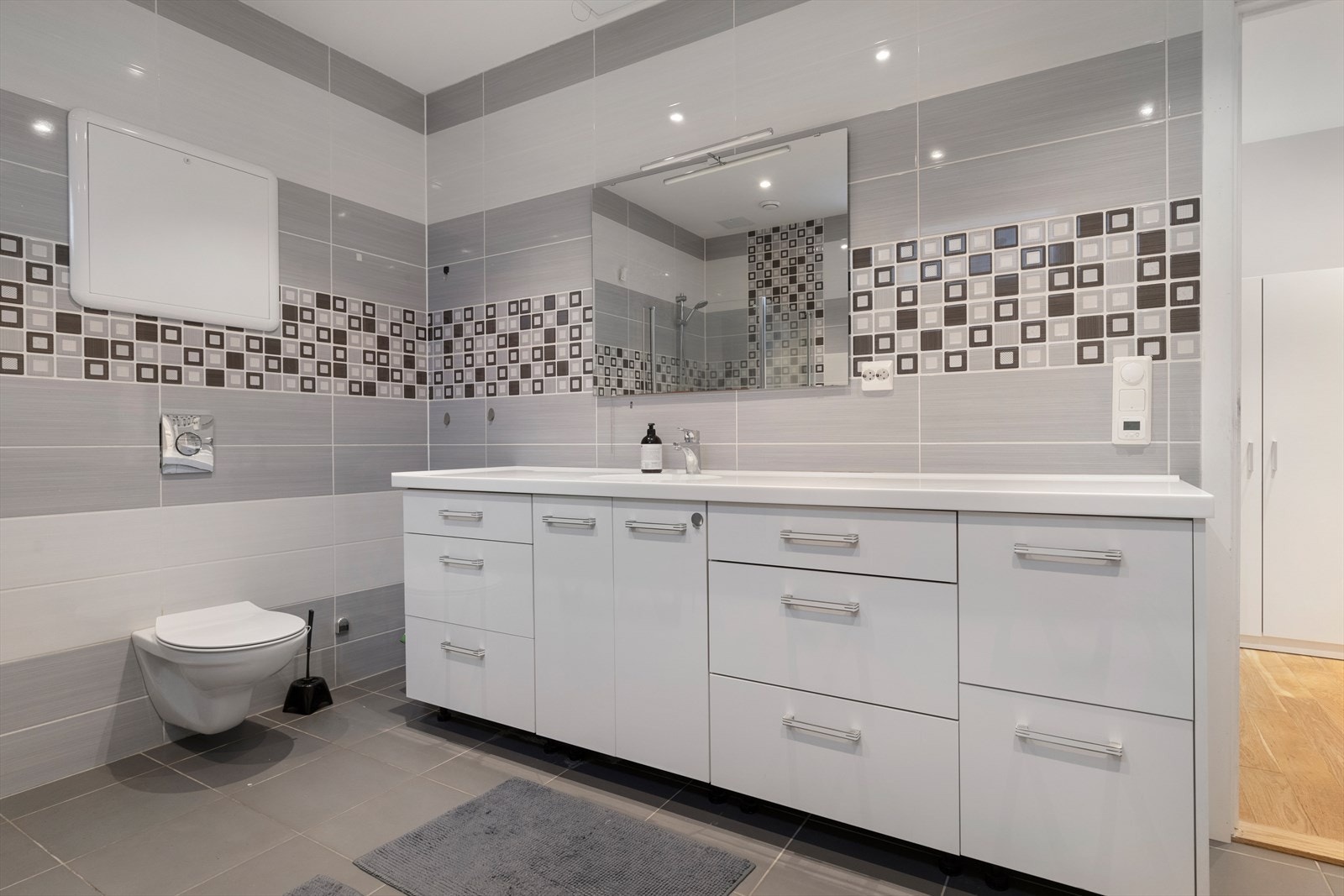 Pent baderom med fliser på gulv og vegger Galleribilde