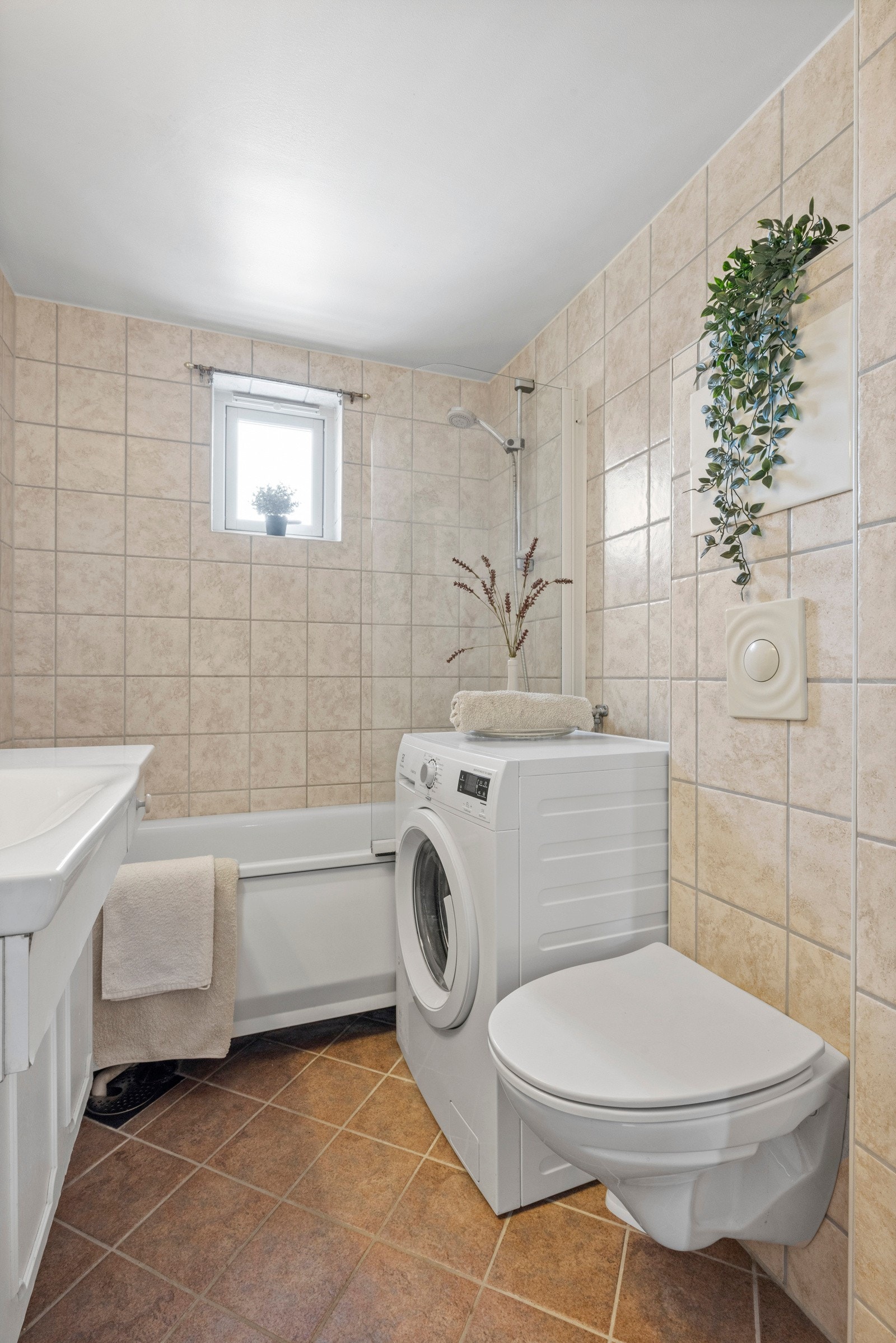 Her finner du opplegg for vaskemaskin, vegghengt toalett og servant - Samt et badekar for en deilig avslutning på dagen Galleribilde