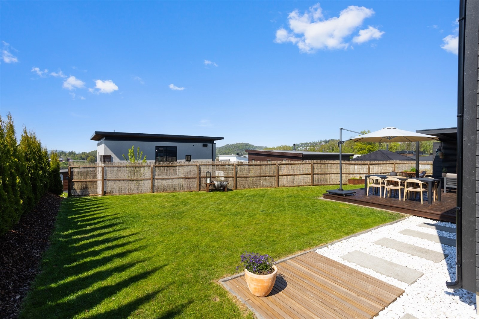 Man sitter meget usjenert i bakhagen med lite innsyn Galleribilde