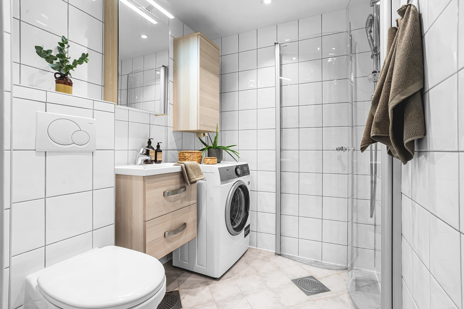 Bad rehabilitert av borettslaget i 2007/08, med LED-downlights og ny dimmer i 2025. Pene fliser, gulvvarme, moderne innredninger, regnfallsdusj og opplegg for vaskemaskin. Galleribilde