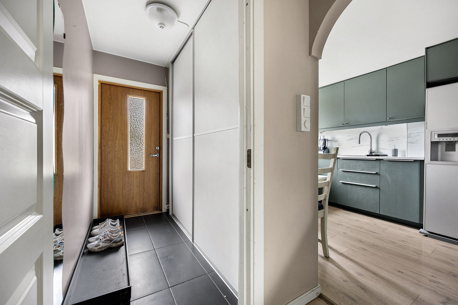 Gang med gode oppbevaringsmuligheter i skyvedørsgarderobe. Galleribilde