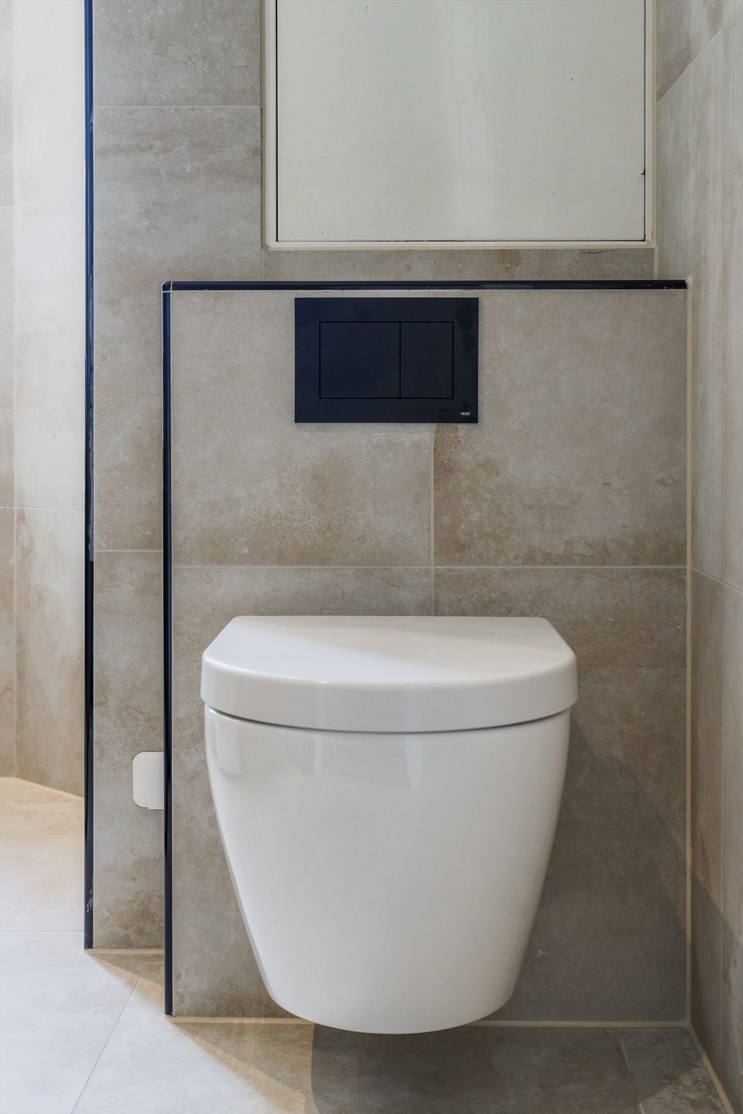 Det er montert vegghengt toalett og opplegg til vaskemaskin, og det er installert elektriske varmekabler i gulvet. Galleribilde