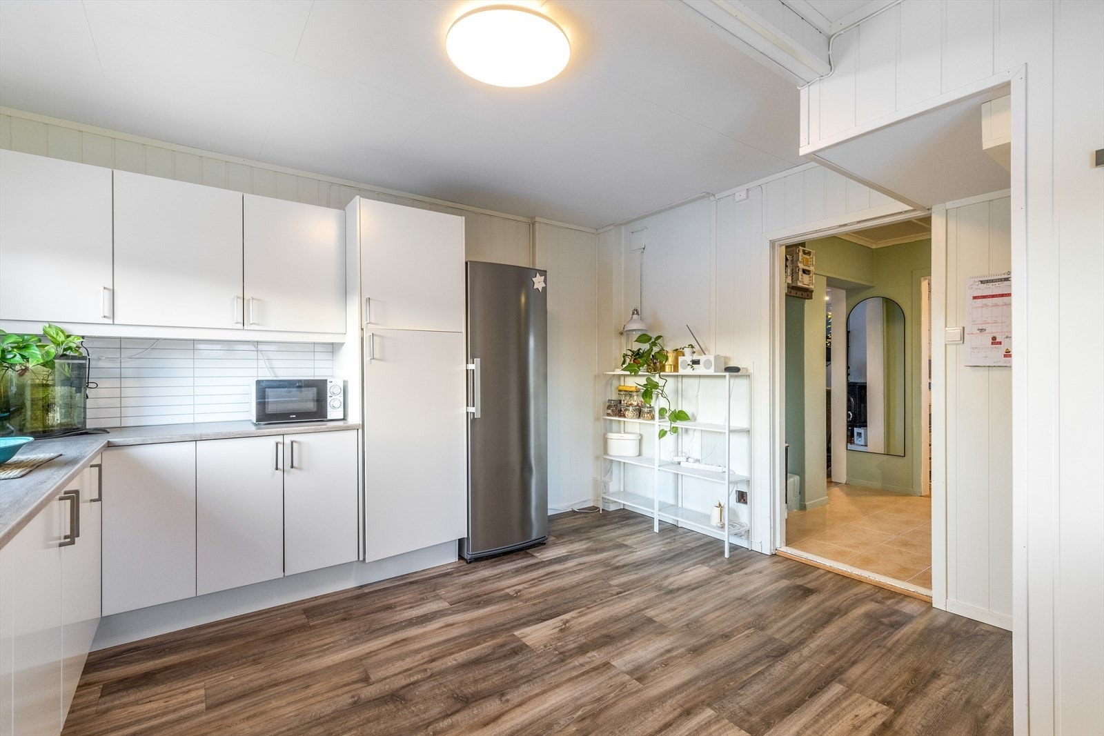 Kjøkkenet har innredning med høyskap, over- og underskap, med laminerte fronter og laminerte skrog. Galleribilde