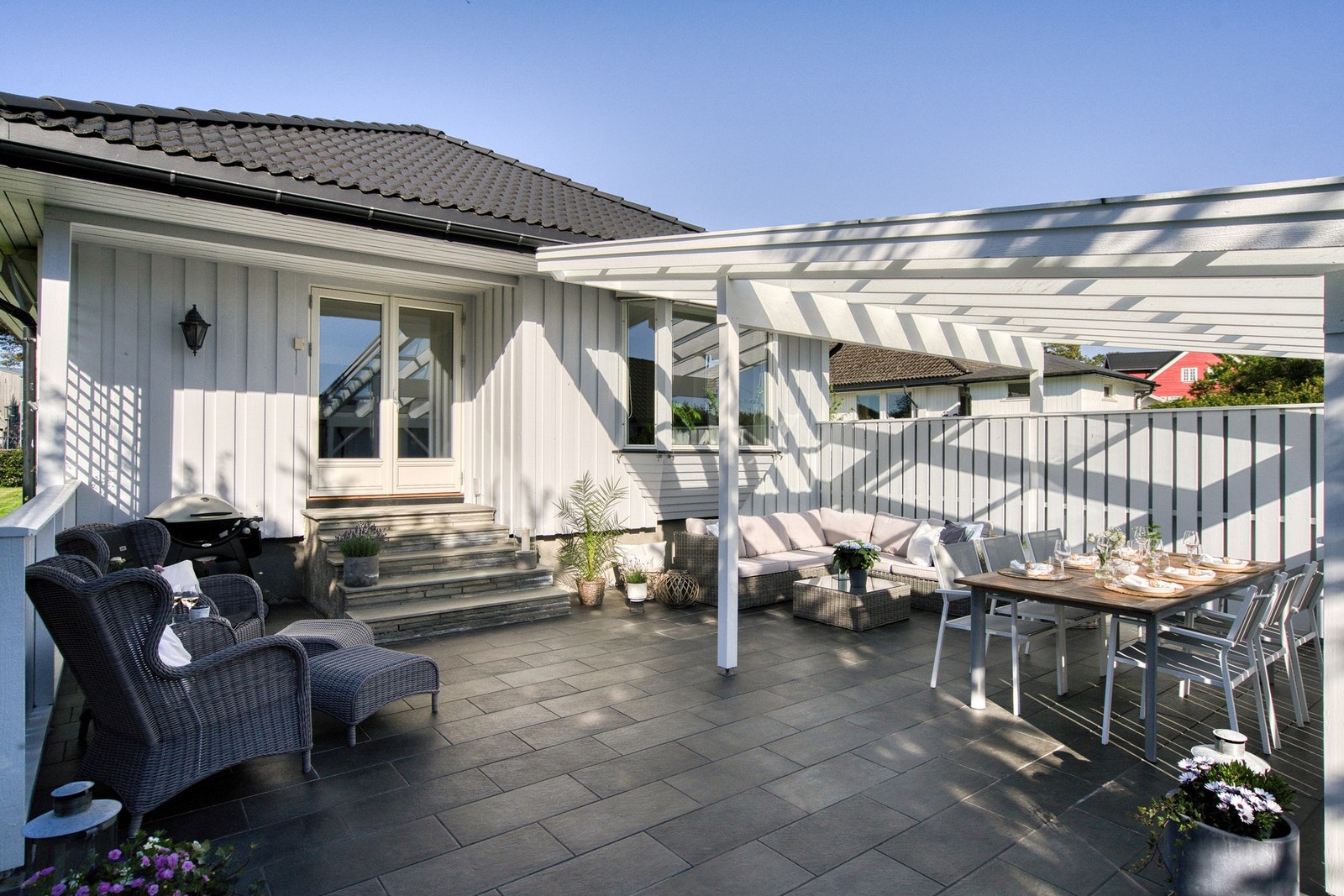 Markterrassen er flislagt og har god plass til flere sittegrupper Galleribilde