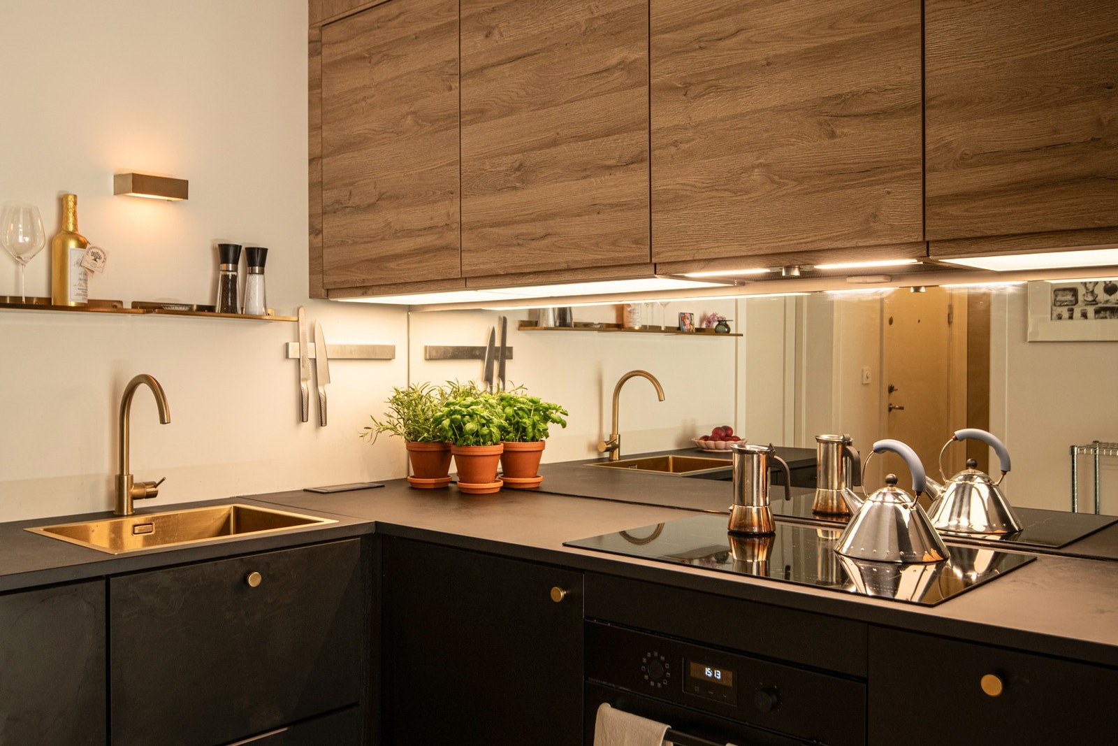 Mellom benkeplaten og overskapene er det montert speil som både gir en følelse av rom og tilfører en moderne touch. Galleribilde