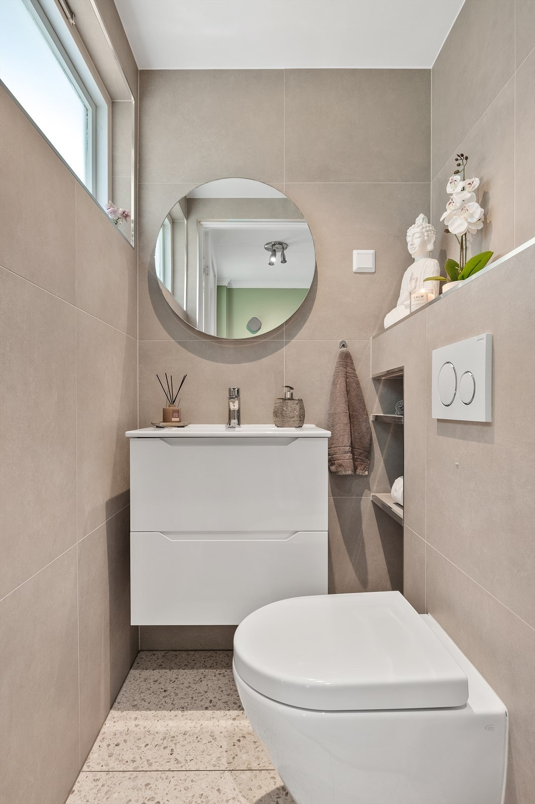 Pent toalettrom med varmekabler i gulv og spotter i taket. Galleribilde