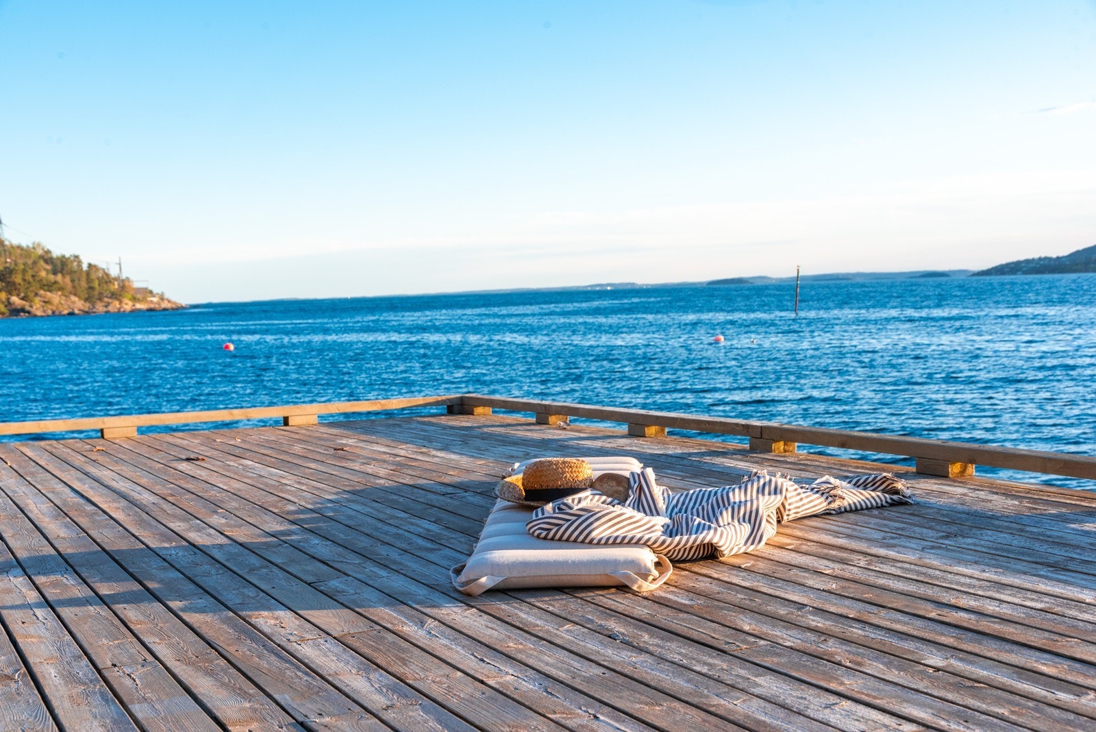 Tredekket på brygga føles lunt under bare føtter. Galleribilde