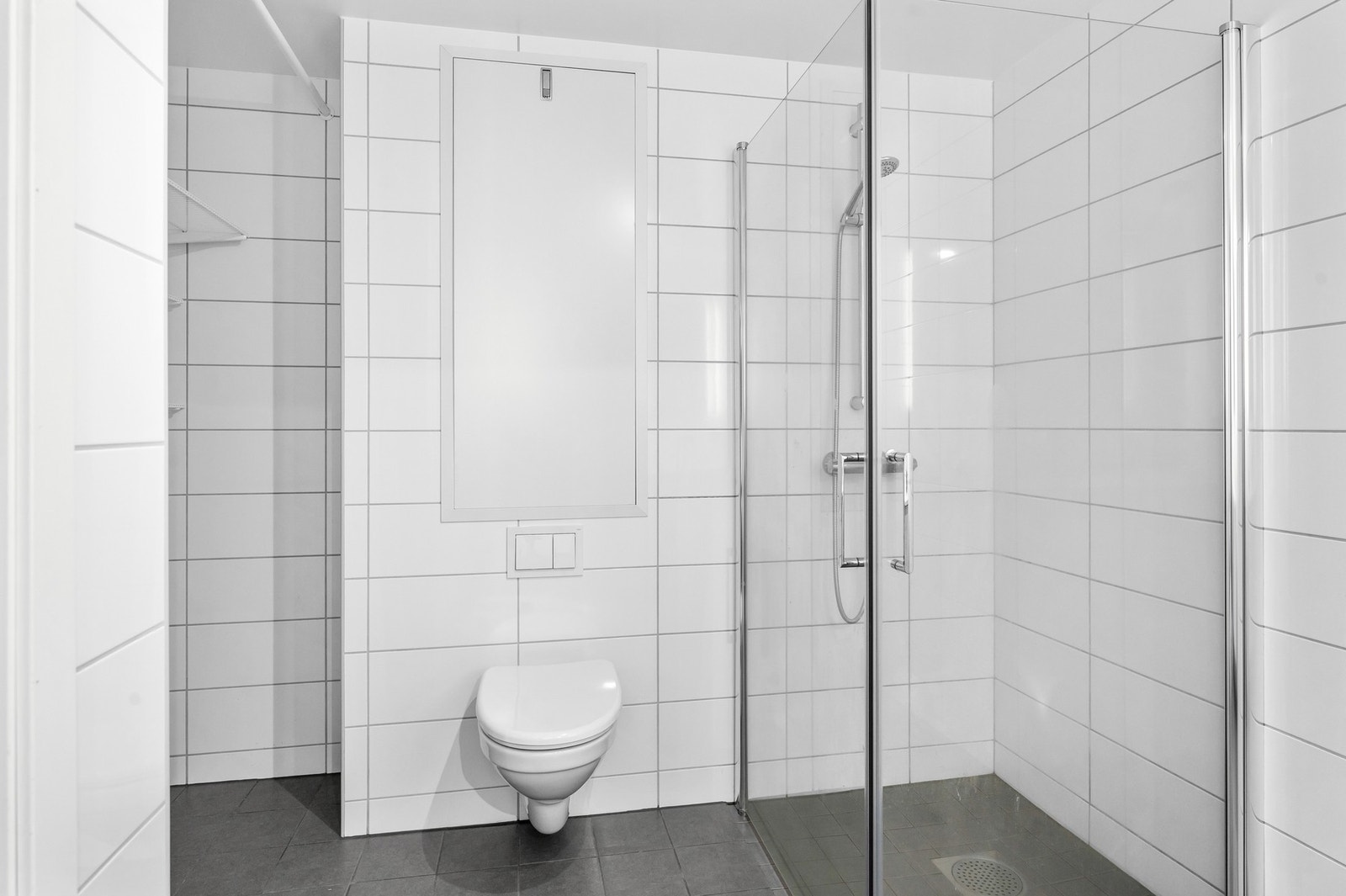 Badet er utstyrt med dusjhjørne og veggmontert wc samt varmekabler i gulv. Galleribilde