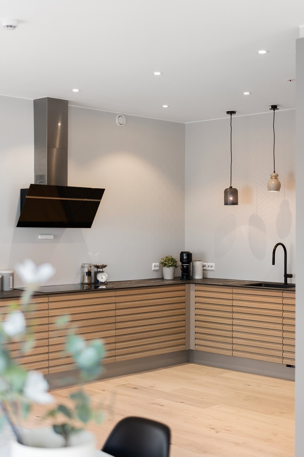 Moderne kjøkken med stilrent design, integrerte hvitevarer og elegante pendellamper. Perfekt for den matglade. Galleribilde