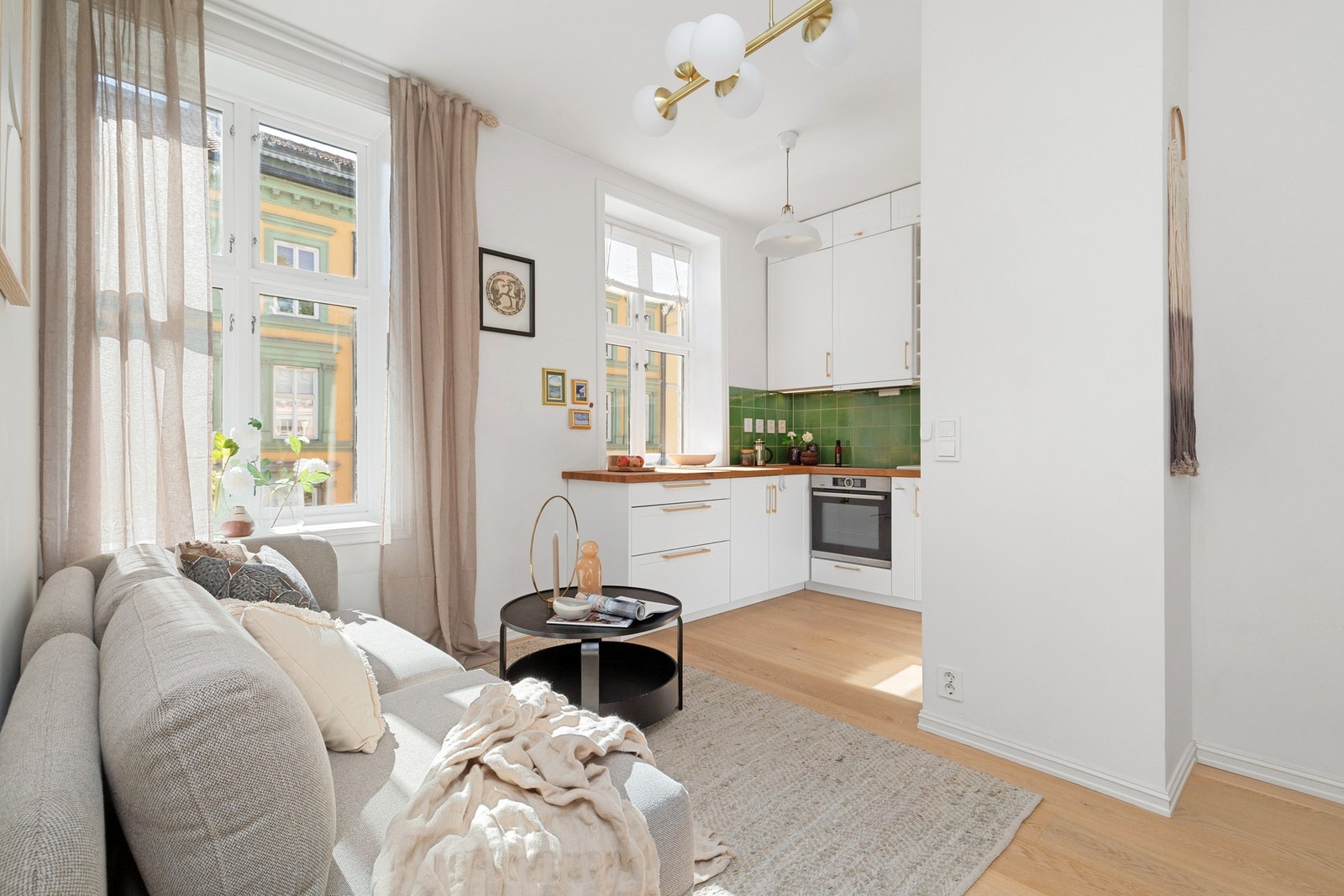 Stue med åpen kjøkkenløsning med plass til både sofa- og spisegruppe. Galleribilde