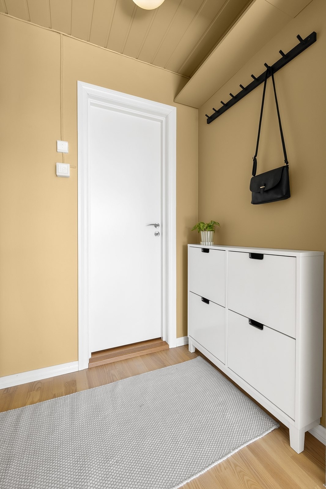 I gangen er det montert skoskap, knaggrekke og veggylle for oppbevaring av yttertøy og sko. Galleribilde