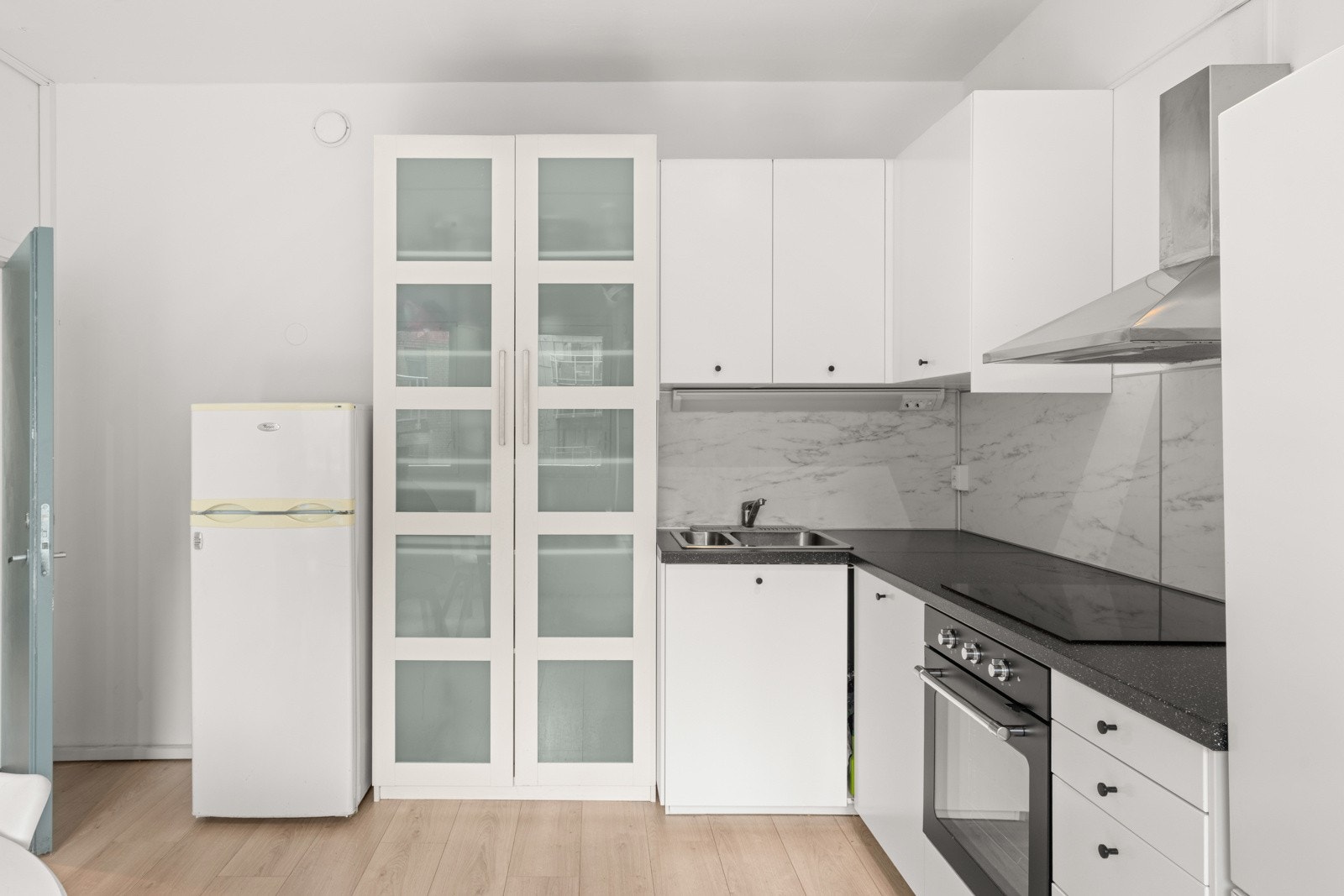 Kjøkkenet ligger separat fra stuen og har en lys, pen innredning med integrert stekeovn og oppvaskmaskin. Frittstående kjøleskap og nedfelt platetopp. Det er montert kullfilter over platetopp og lekkasjestopper under oppvaskkum. Galleribilde