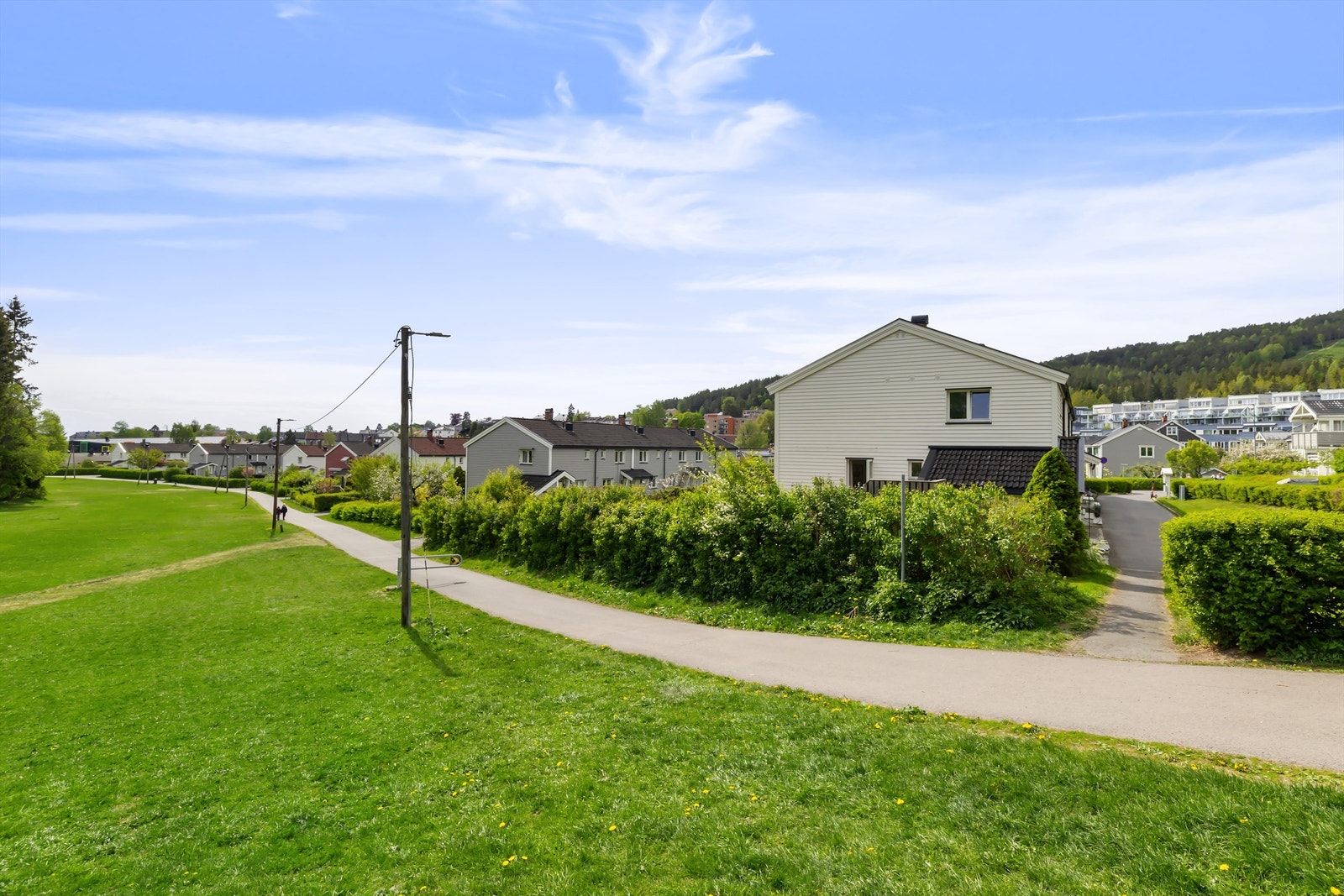 Her løper og sykler barn på bilfrie veier mellom rekkehusene - ren barndomsidyll Galleribilde