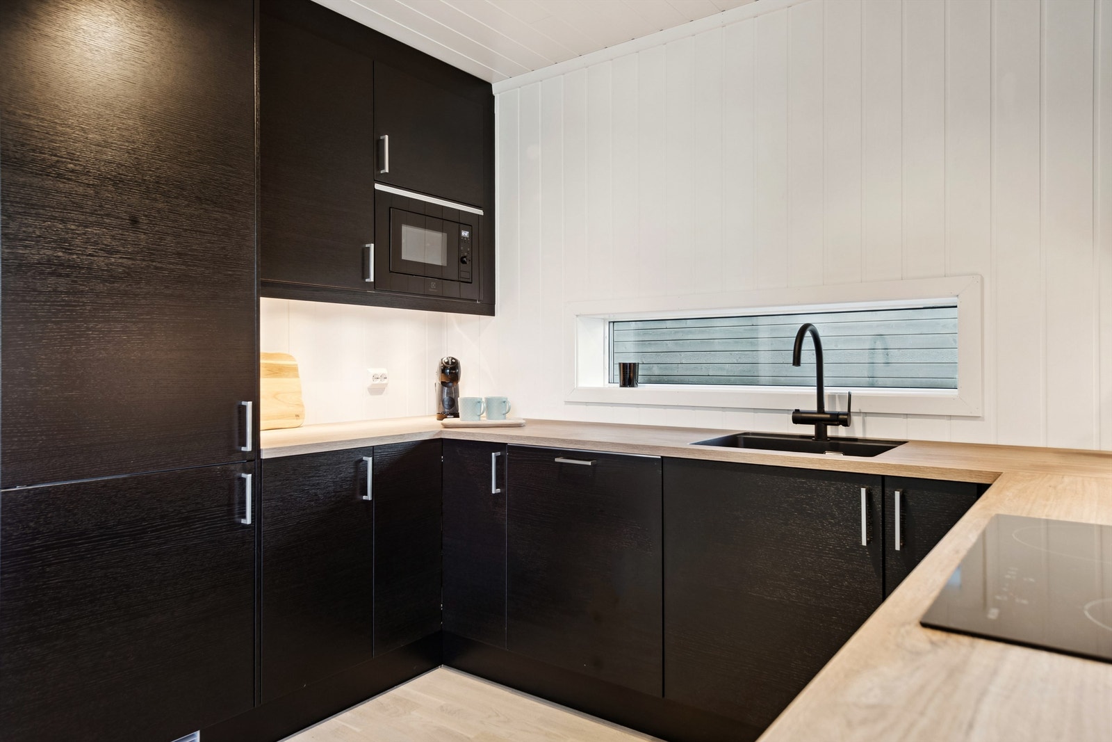 Integrerte hvitevarer som kjøl-og fryseskap, oppvaskmaskin, stekeovn, koketopp og micro. Galleribilde