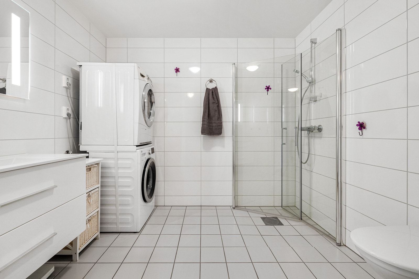 Lyst og moderne bad med opplegg for vaskemaskin. Galleribilde