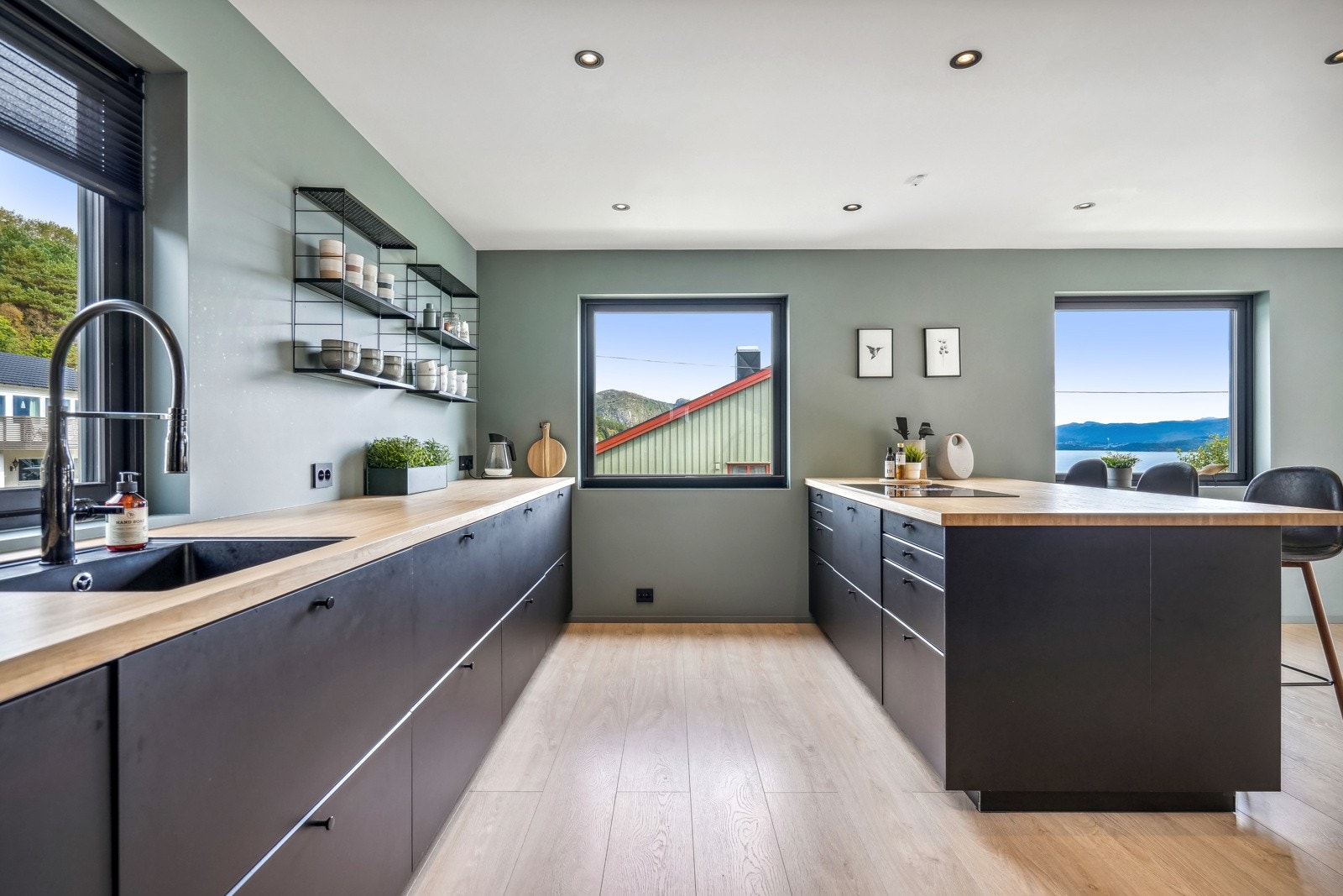 Kjøkkenøyen har skap på begge sider og god plass til barkrakker Galleribilde