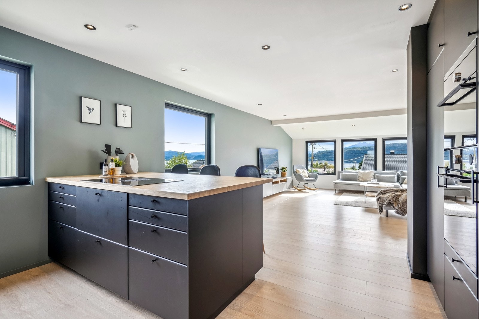 Kjøkken og stue i åpen praktisk løsning. Kjøkkenøya er utstyrt med 80cm bred platetopp Galleribilde