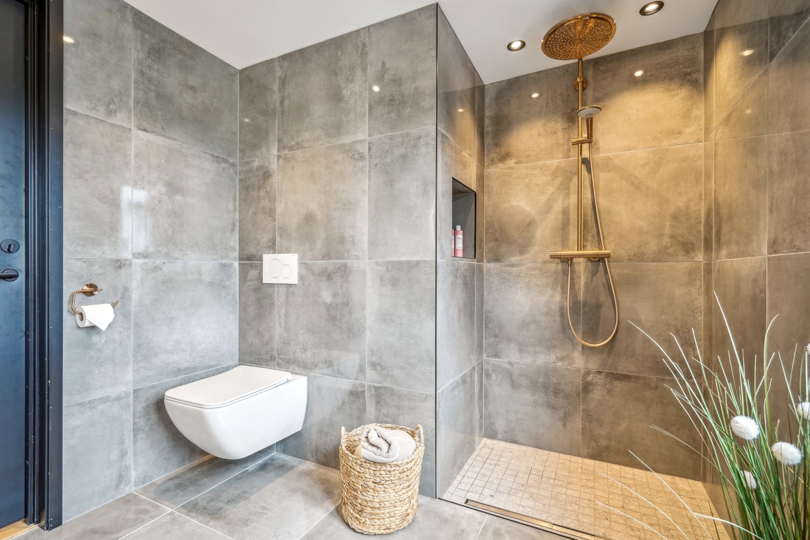 Videre er det vegghengt toalett og dusj i kobber med innebygd dusjhylle Galleribilde