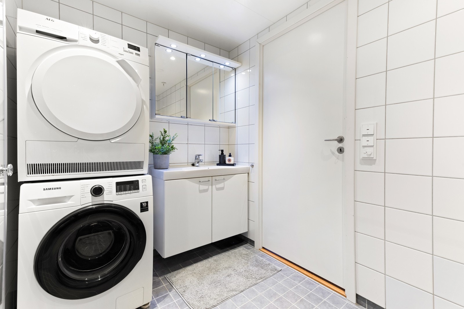 Baderommet er moderne og funksjonelt, med fliser på vegger og gulv samt innfelte downlights i taket. Galleribilde