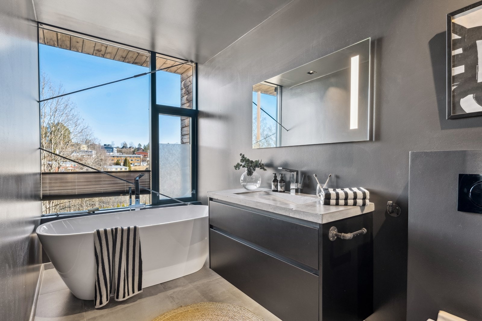Badet har frittstående badekar med stående dusjarmatur fra Grohe og stor dusjnisje. Galleribilde