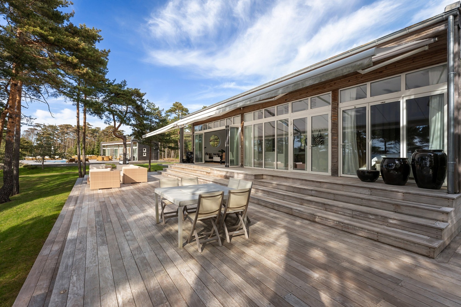 Hele frontfasaden i glass hvor store deler kan åpnes mot terrassen. Galleribilde