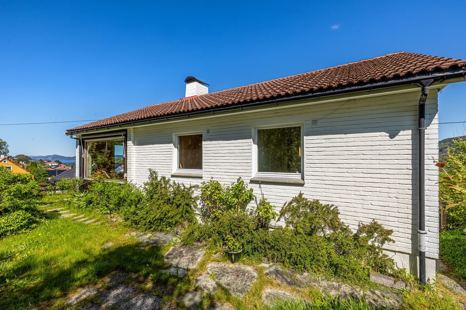 Opparbeidet og beplantet hage med gangveier, prydbusker mm. , men noe overgrodd. Galleribilde