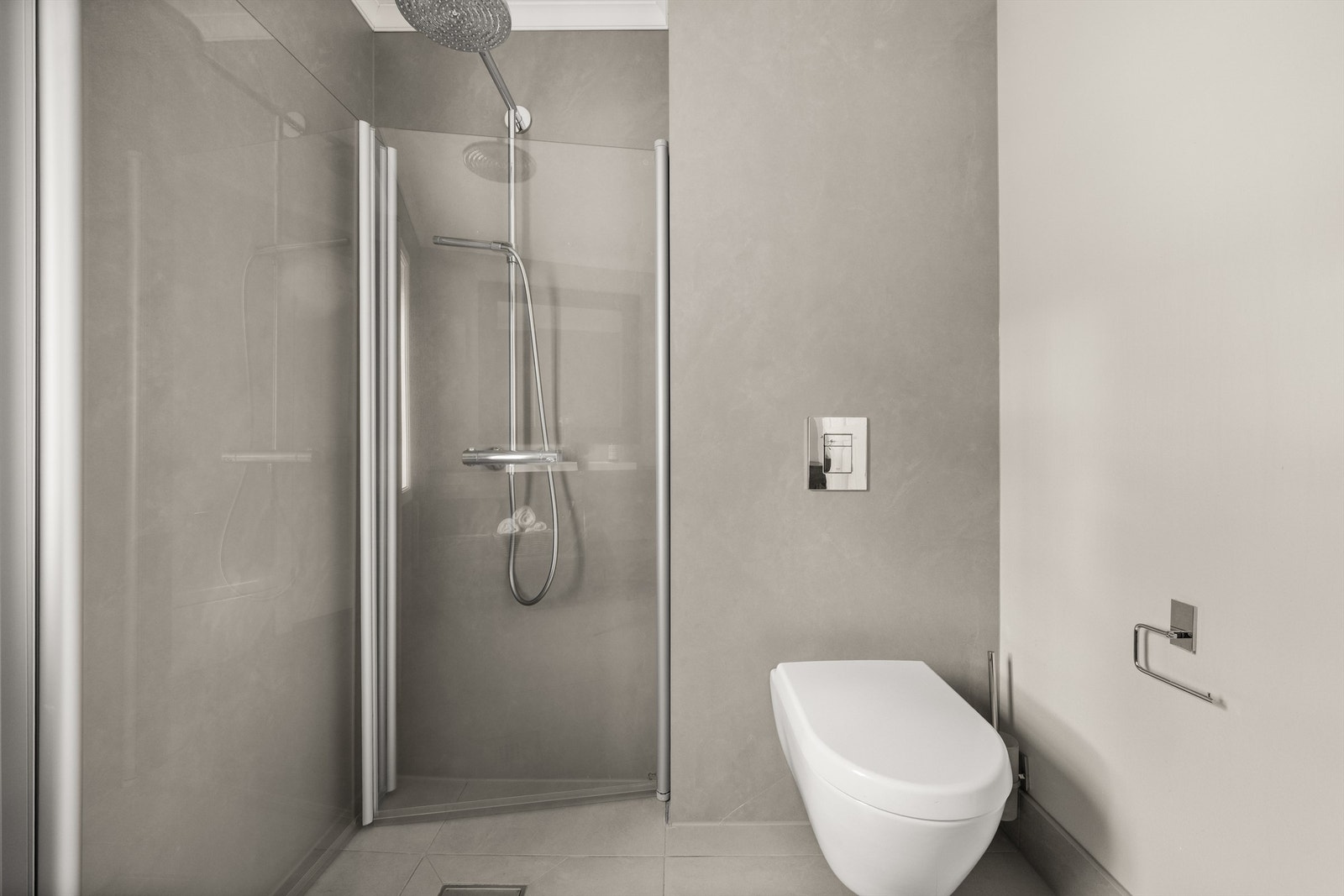 Badet har dusjhjørne med foldedører av glass og regnfallsdusj Galleribilde