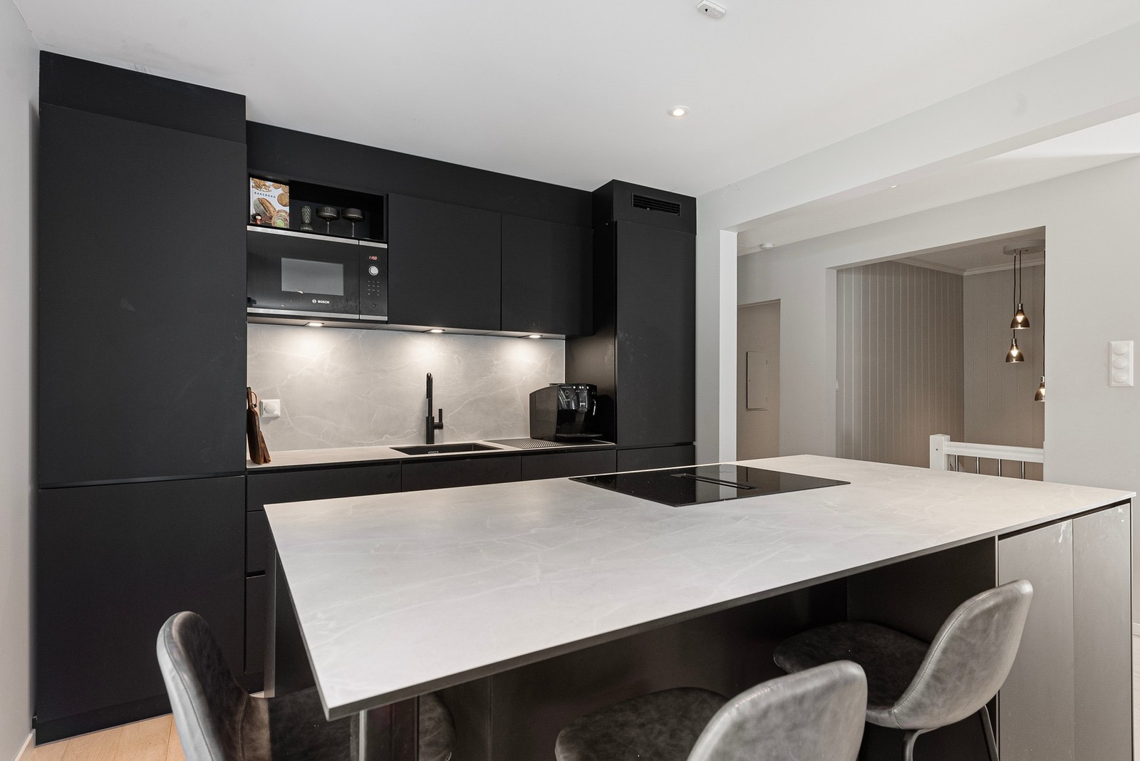 Her har du rene rette linjer og moderne mørk innrending som definerer kjøkkenområdet i rommet Galleribilde