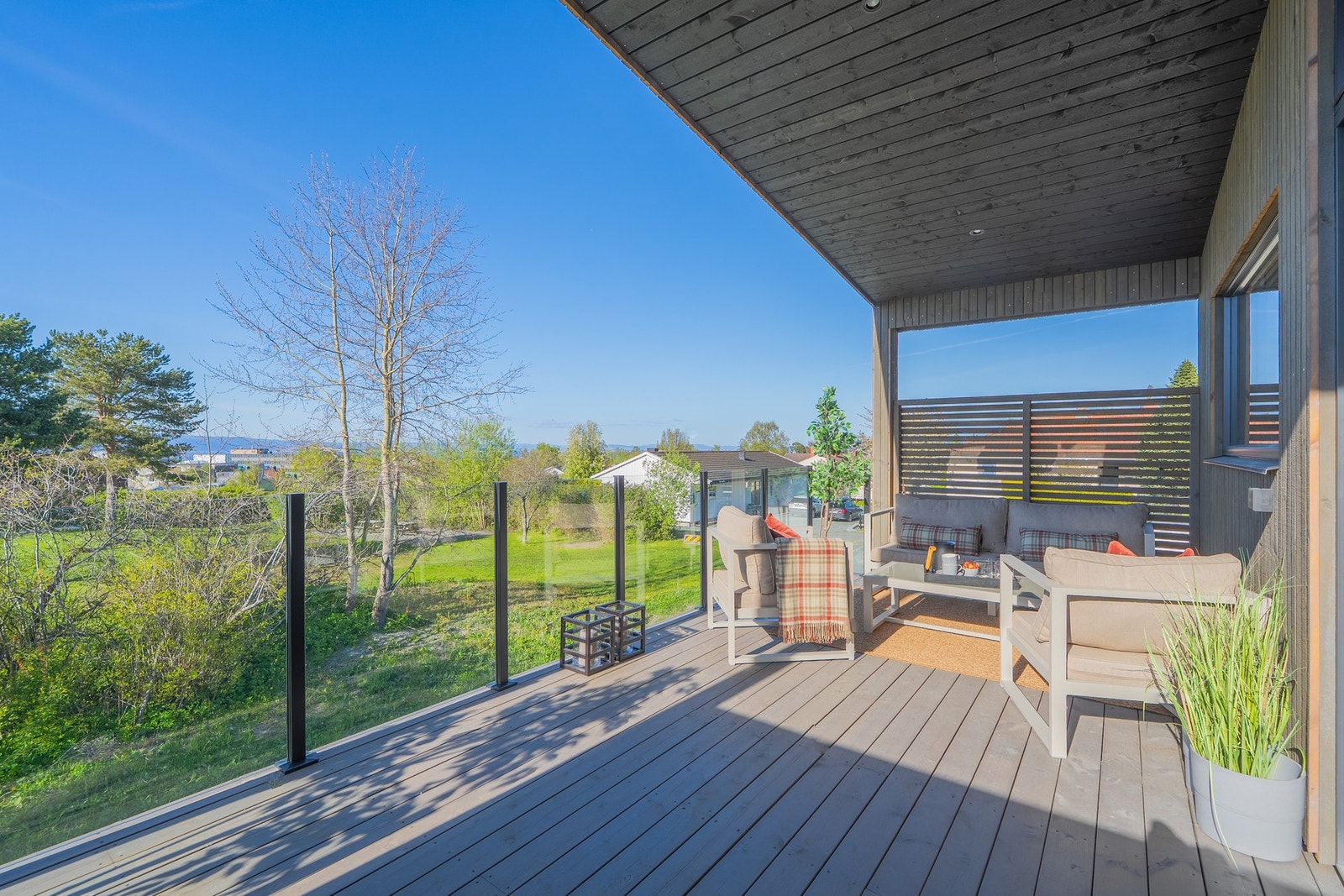 Boligen grenser til kommunalt friområde, så her sitter du usjenert til og nyter en herlig utsikt over grøntarealet. Glassrekkverket forsterker dette ytterligere. Galleribilde