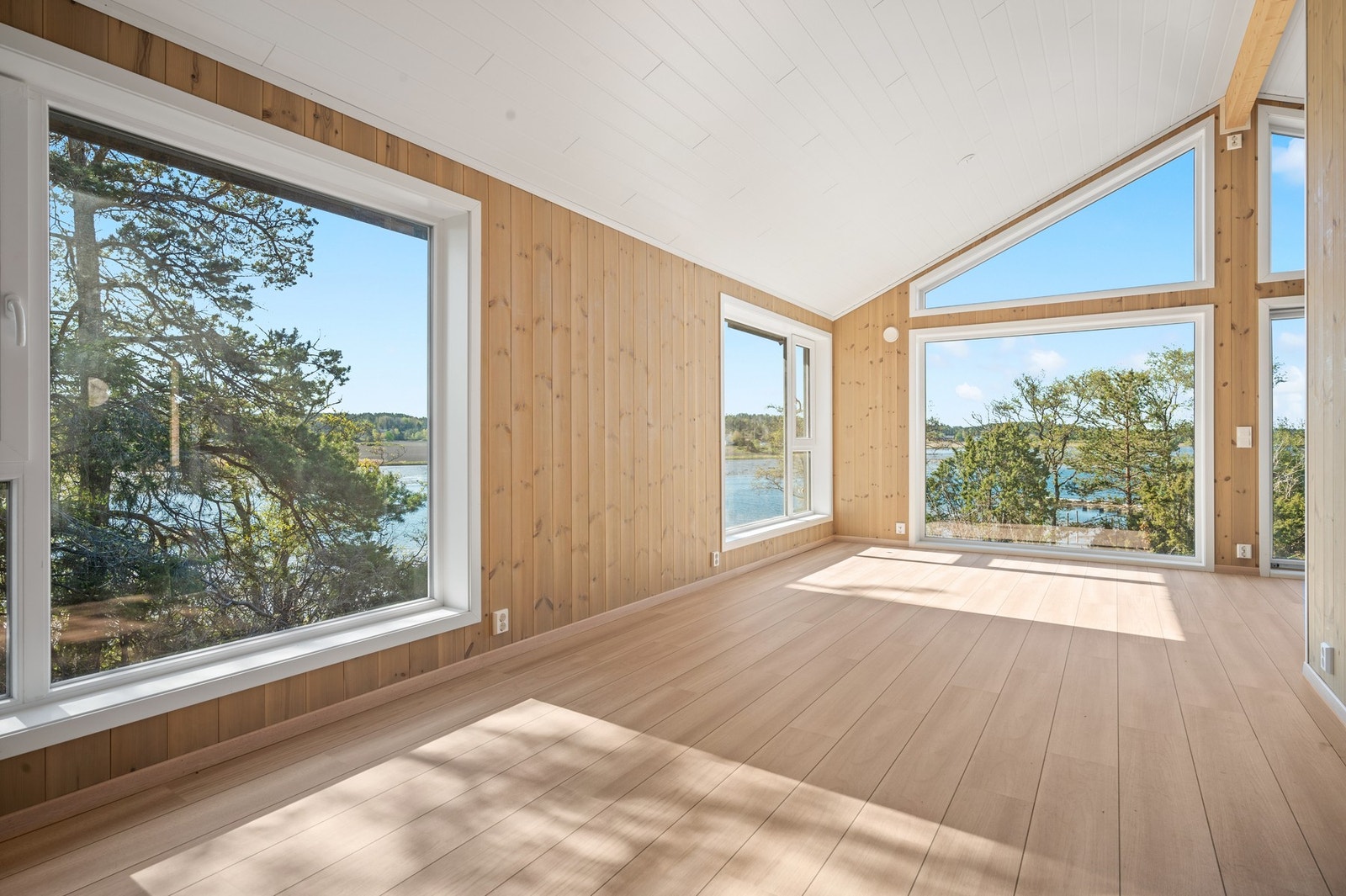 Her er det plass til både sofagruppe og spisebord, og store vindusflater gir flott utsyn mot natur og sjø. Galleribilde