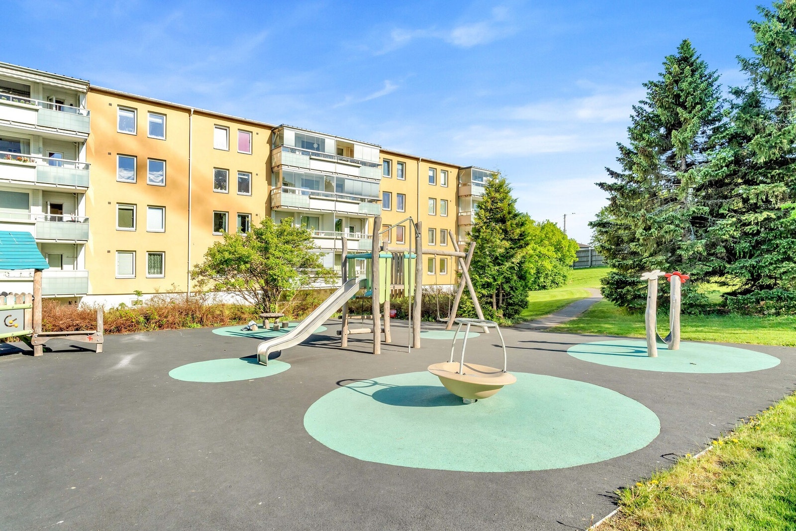 Fellesområdet opparbeidet med blant annet biloppstillingsplasser, internstier, sykkelstativer, lekeapparater, sittebenker, plenarealer og diverse beplantning. Galleribilde