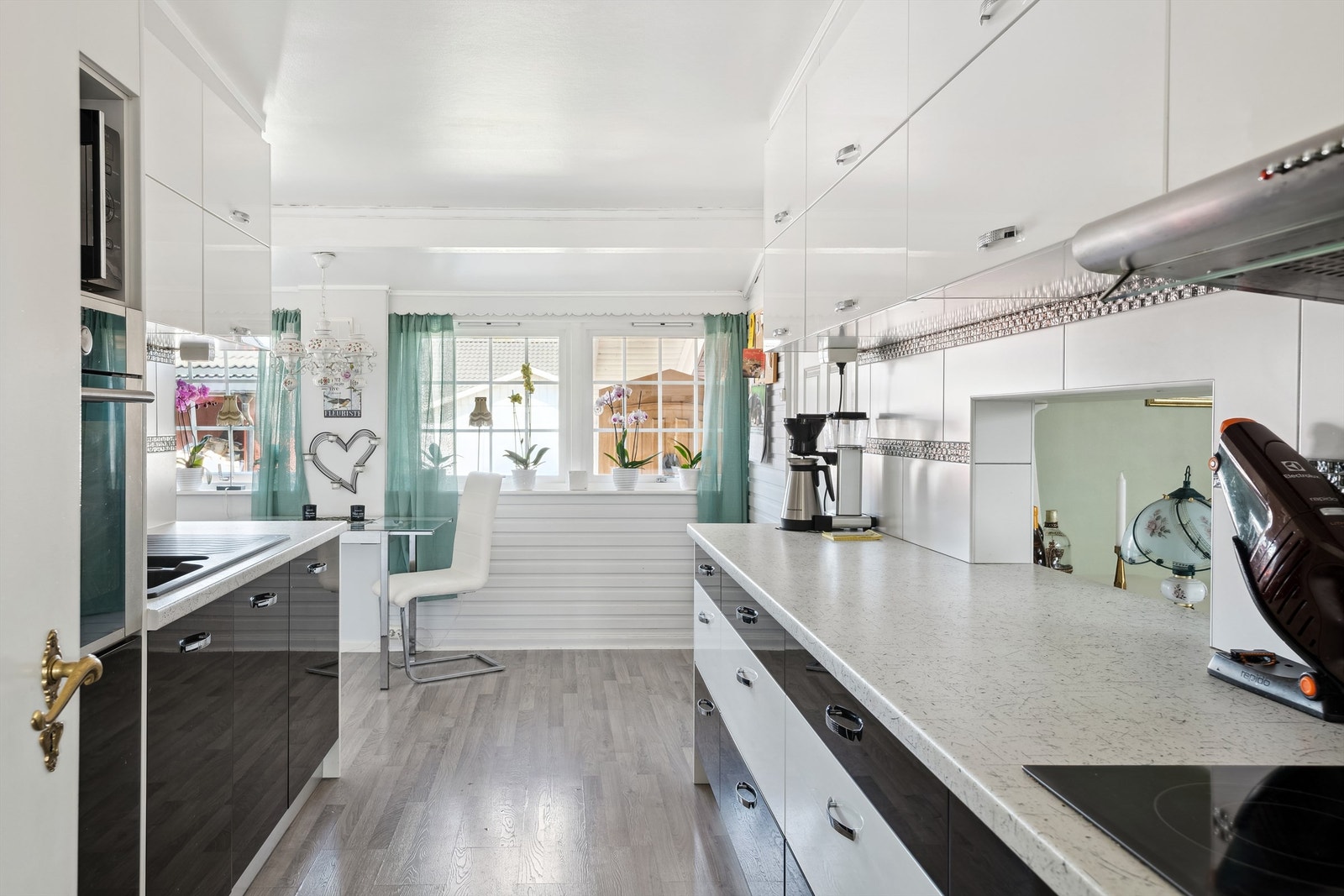 Kjøkkenet er utstyrt med integrerte hvitevarer med koketopp, stekeovn og oppvaskmaskin. Ventilator over koketopp. Serveringsluke i benkerygg mot stue Galleribilde