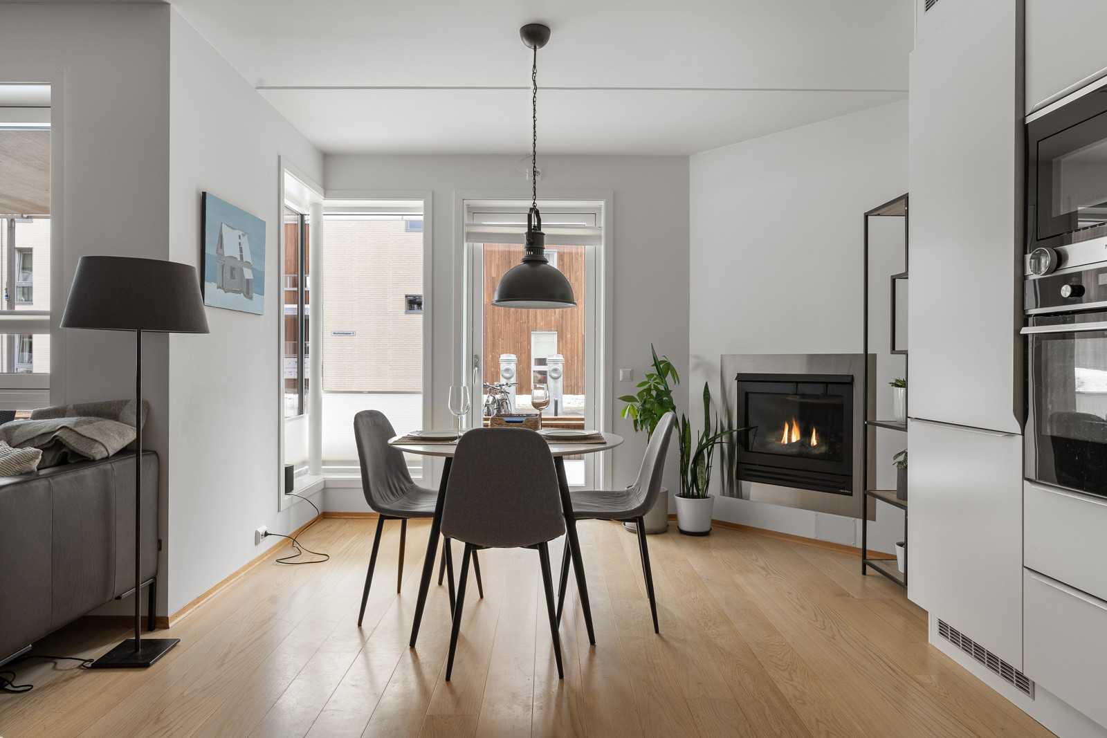 Spisebordet har sin plass like ved kjøkkenet. Store vindusflater slipper inn rikelige mengder med naturlig lys i rommet.