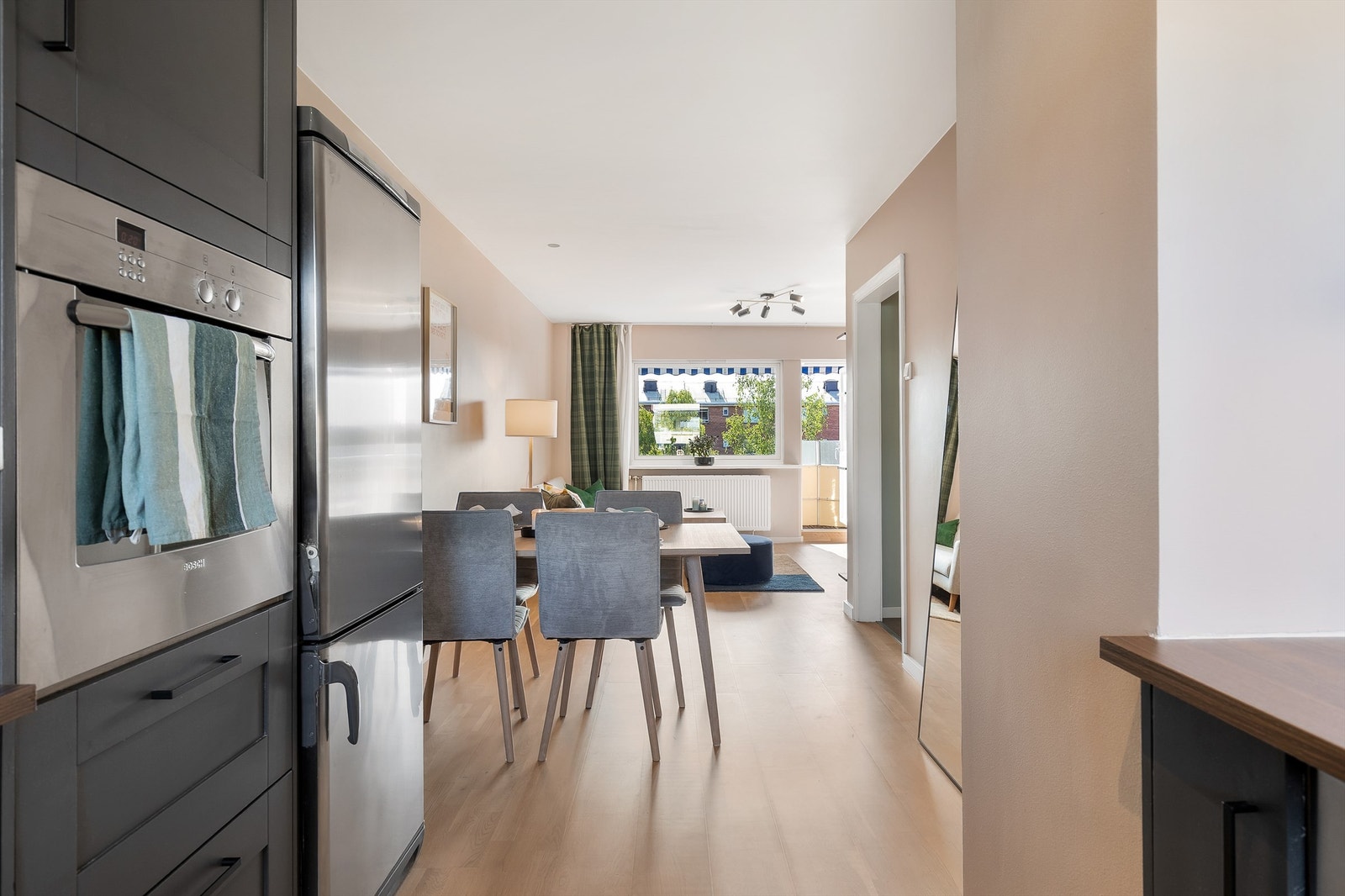 Det mørke kjøkkenet gjør at rommet naturlig deles inn i separate soner. Galleribilde