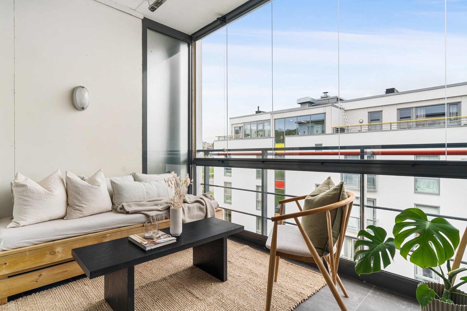 Via skyvedør i stuen er det adkomst til en innglasset balkong på 8 kvm. Balkongen har flislagt dekke og vindu som kan åpnes og lukkes etter behov. Rommet blir en forlengelse av stuen og et lunt, behagelig uterom som er anvendelig store deler av året. Galleribilde