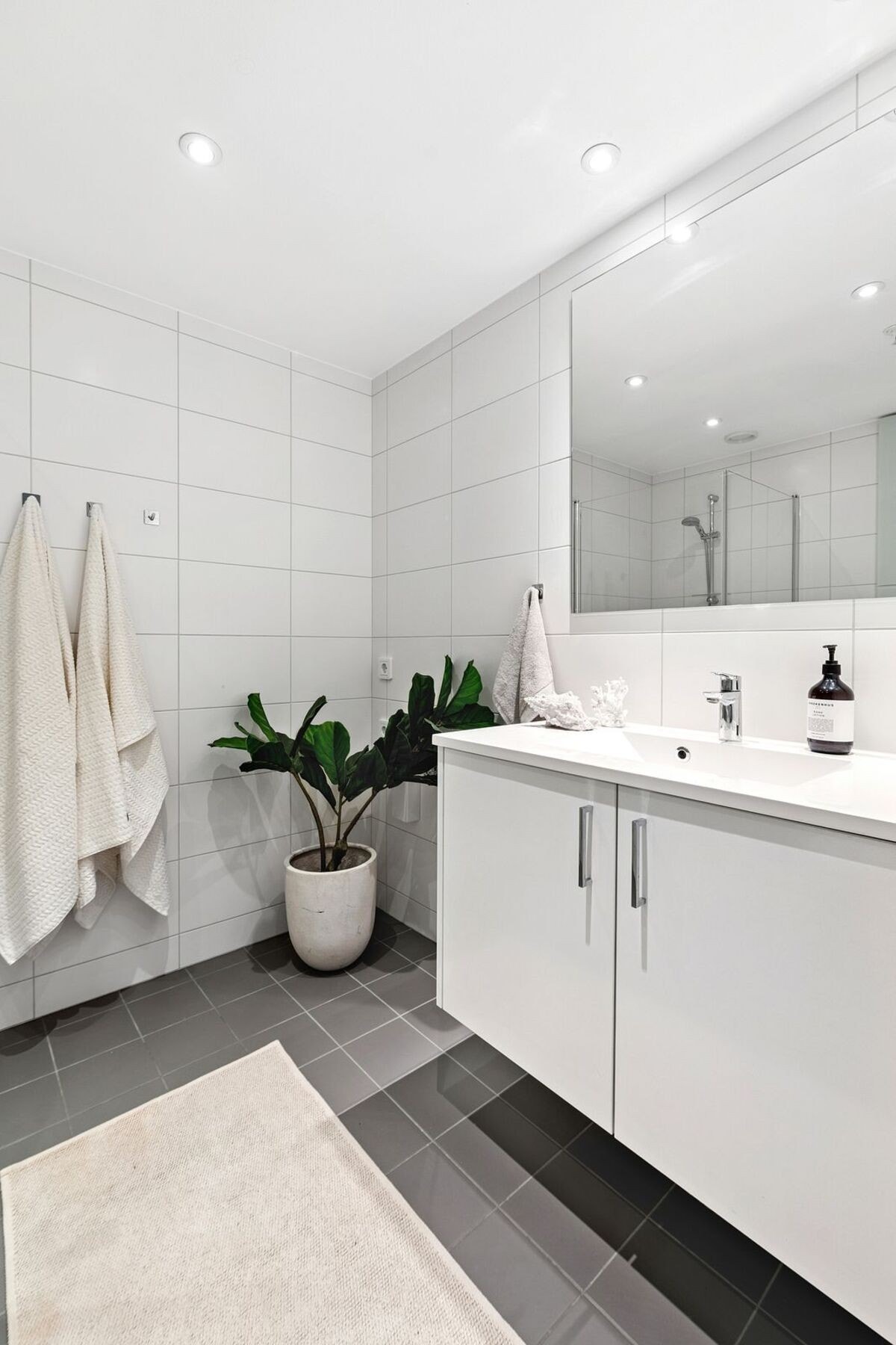 Badet har romslig innredning og praktisk opplegg for vaskemaskin/tørketrommel ved siden av Galleribilde