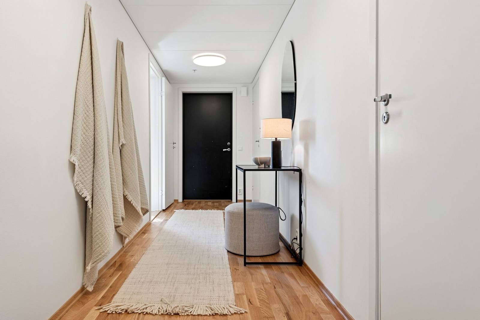 Innvendig møtes du av en lys og romslig entré og gang, som gir en hyggelig velkomst inn i boligen Galleribilde