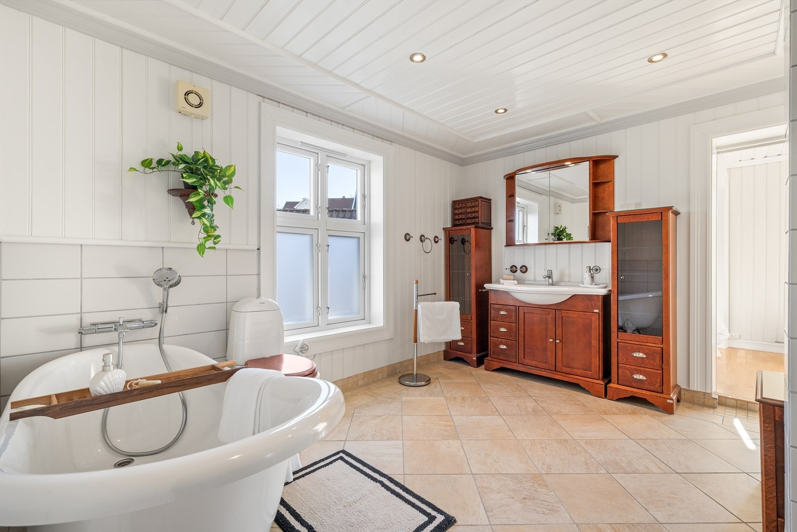 Pent flislagt baderom med varmekabler i gulv og downlights i tak. Galleribilde