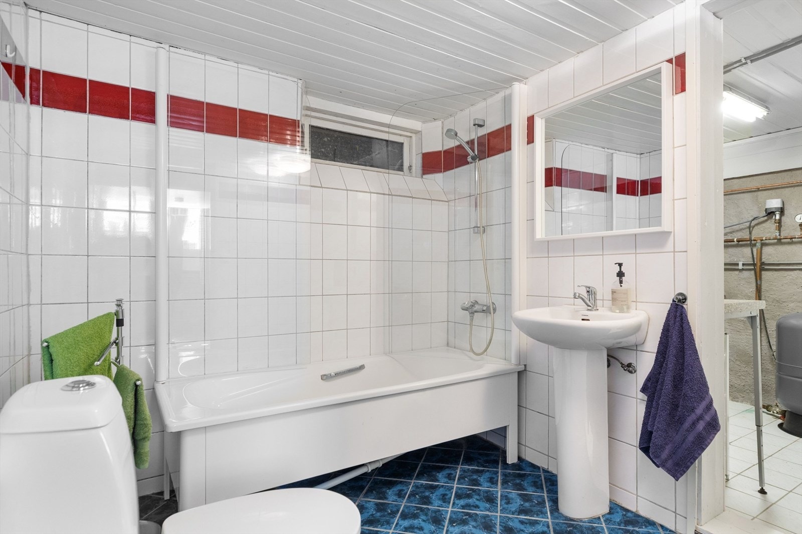 Badet i kjelleren er helfliset, og måler ca. 5m². Innenfor badet er det et separat vaskerom på ca. 5m². Galleribilde