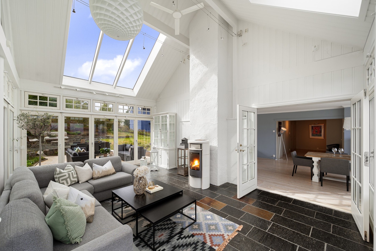 Med utgang til hage på den ene siden og stue på den andre, fungerer vinterhagen som et sosialt midtpunkt. Galleribilde