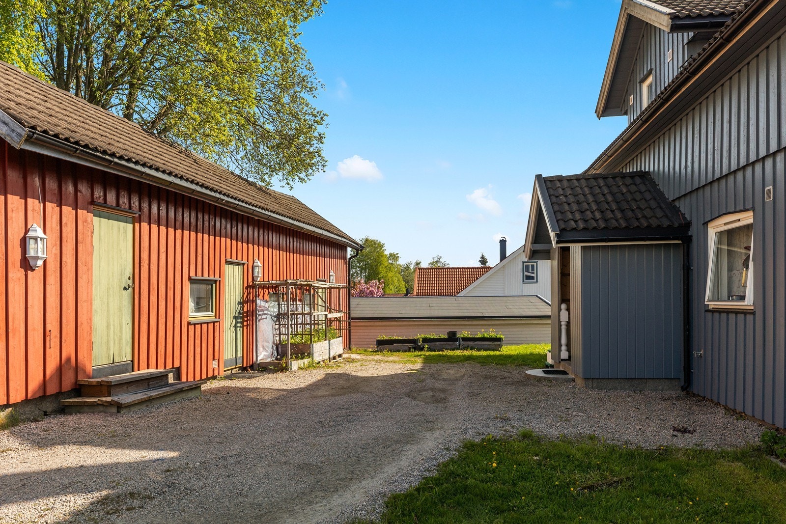Gruset og romslig gårdsplass, med rom for parkering av flere biler. Galleribilde