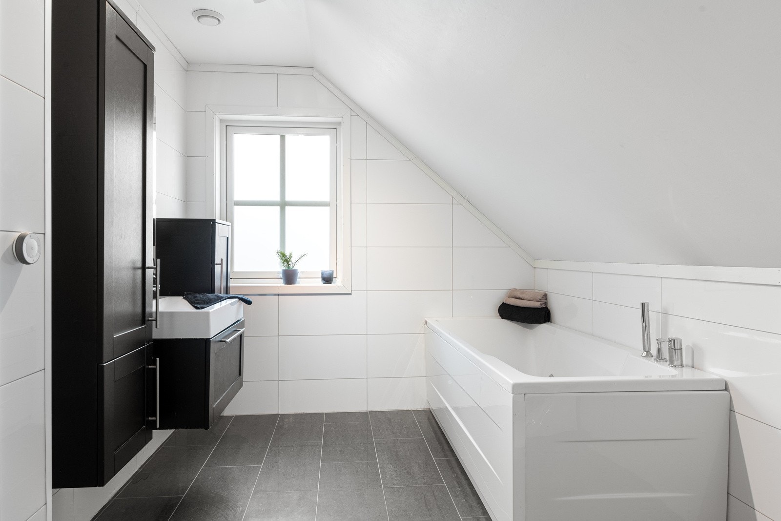 Bad 2. etasje med badekar, dusjnisje, WC og pen innredning med servant og speil. Galleribilde