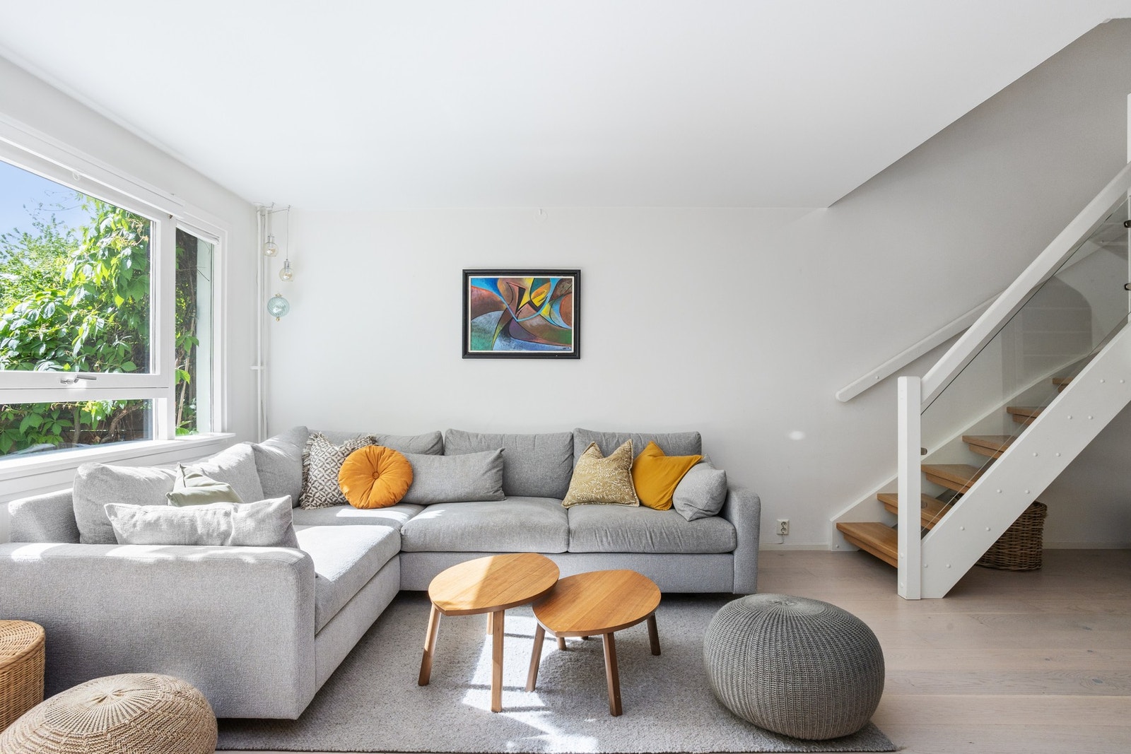 Lys stue med plass til stor sofa. Det er trapp opp til 2. etasje i stuen. Galleribilde