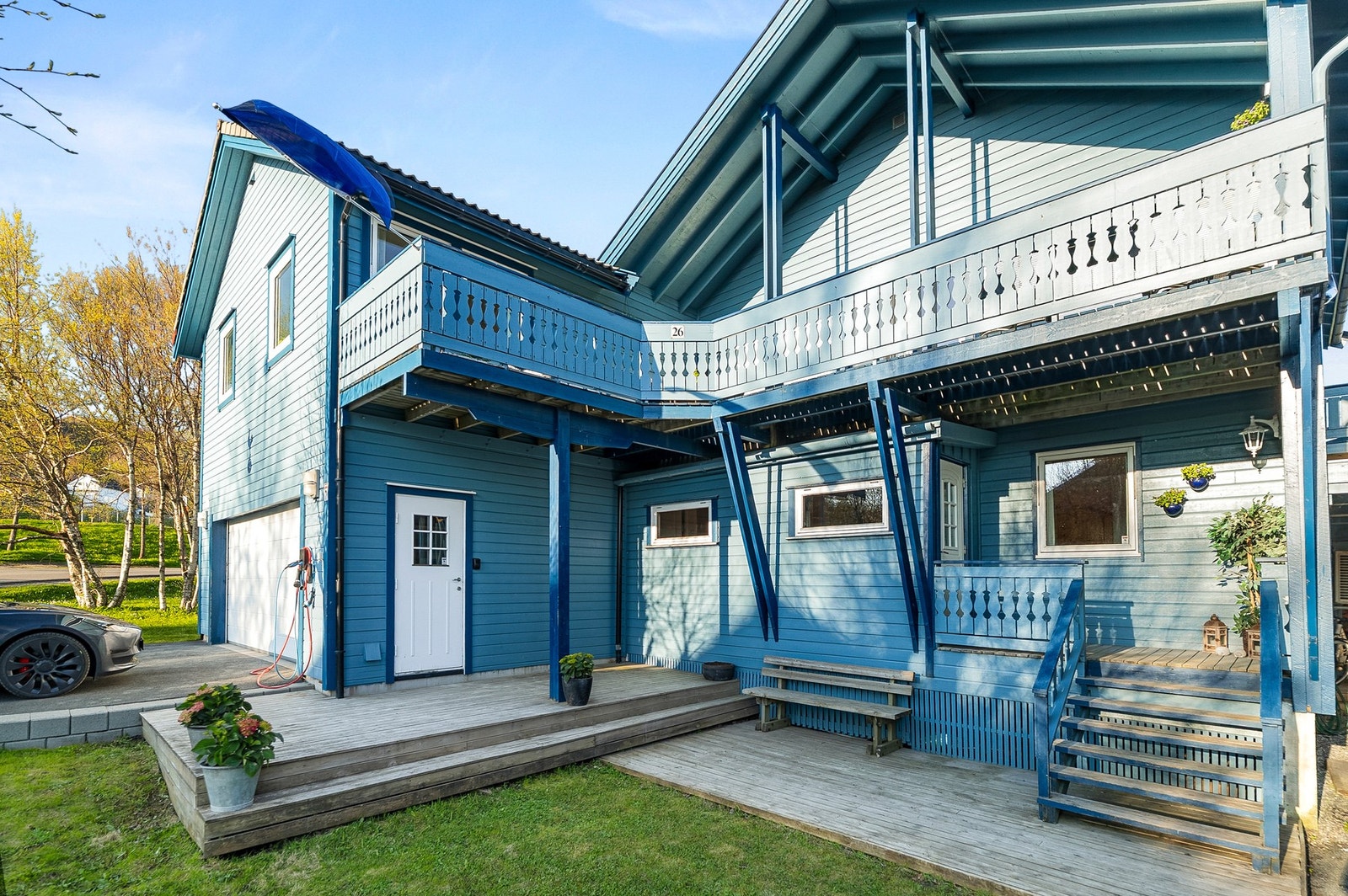 Takoverbygget inngangsparti med stor solrik altan ovenfor. Egen dør inn til garasje. Mellomgang mellom hus og garasje. Galleribilde