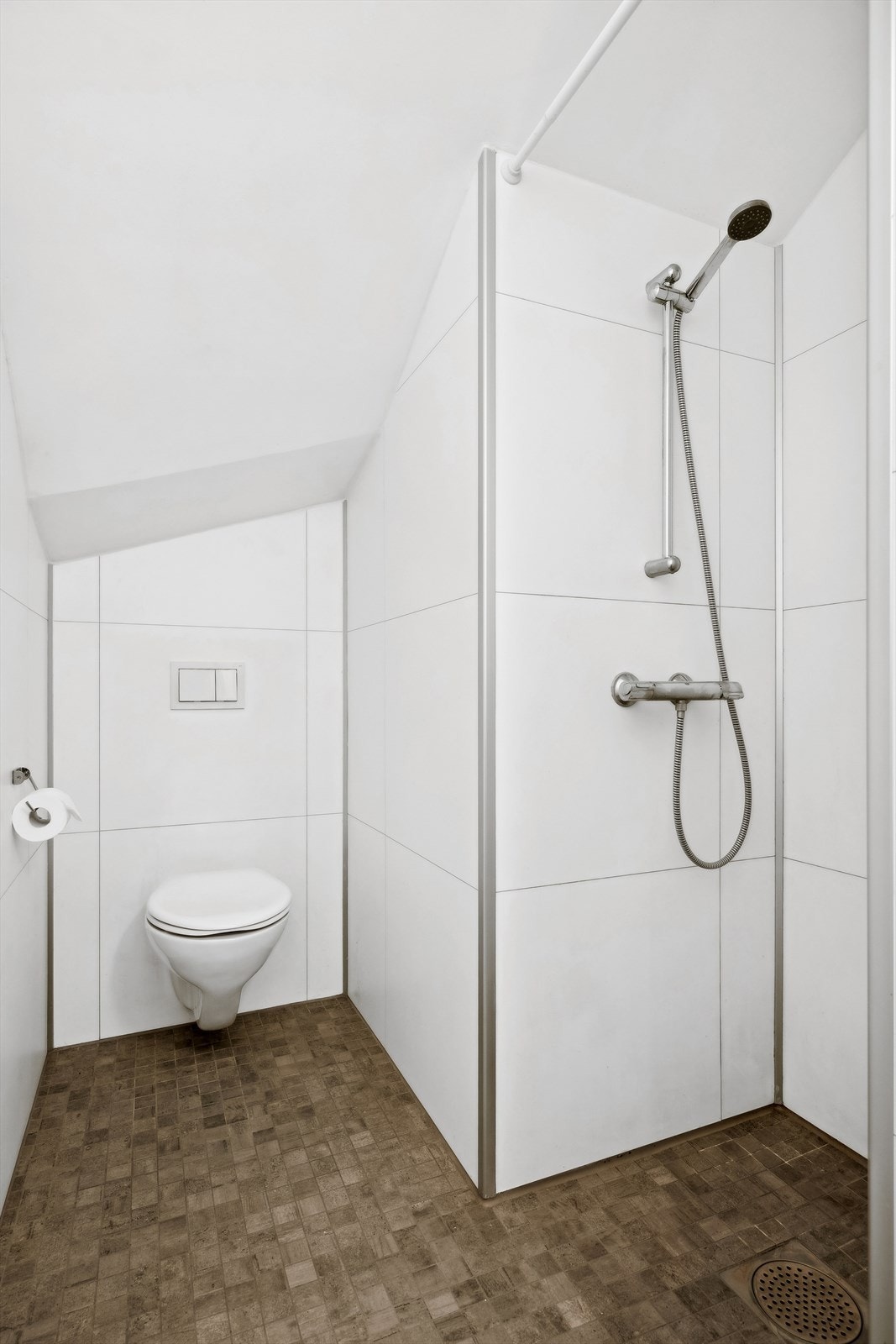 Badet har vegghengt toalett, innredning med servant og dusjnisje. Galleribilde