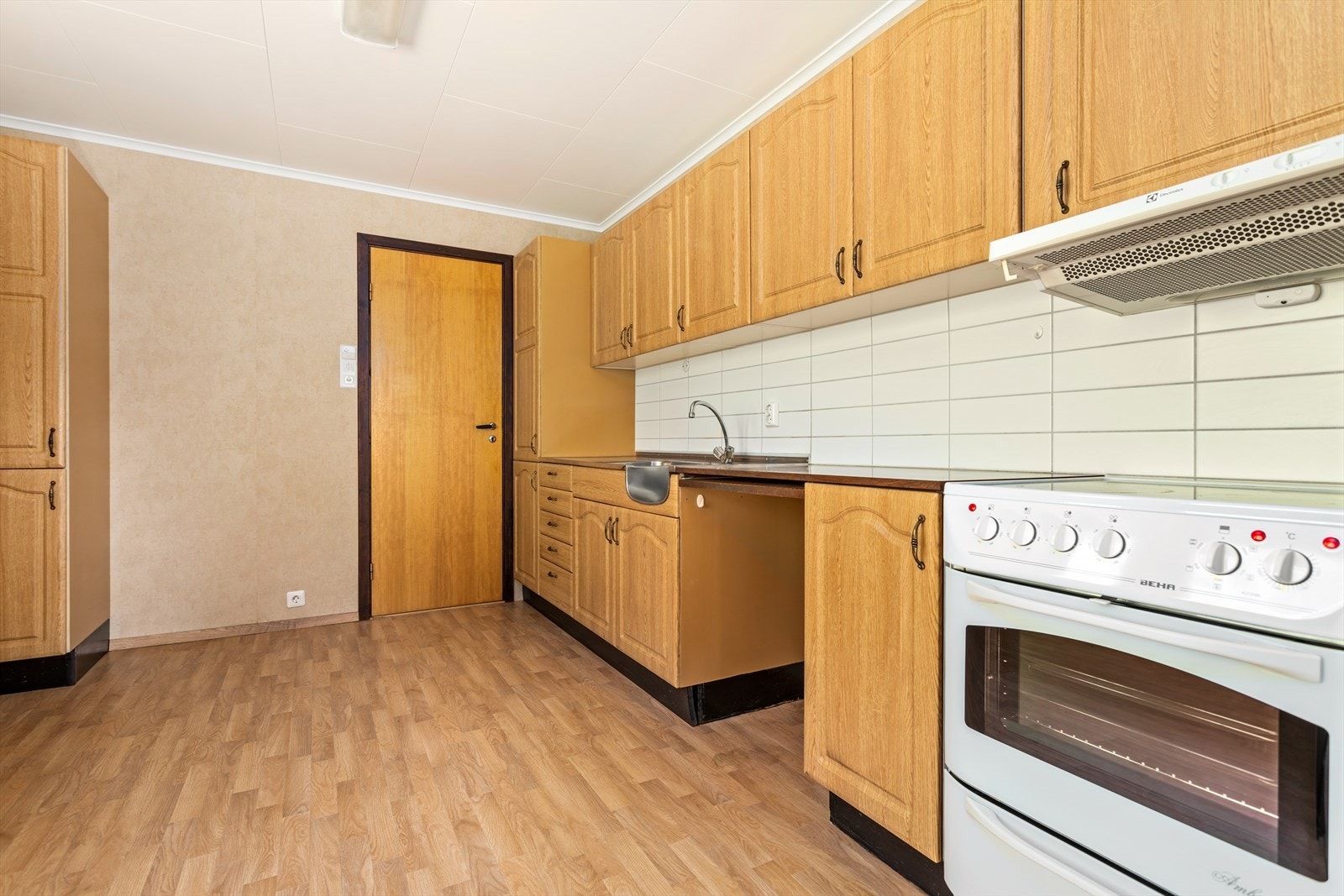 Kjøkkenet har innredning med profilerte frontar og benkeplate av laminat. Galleribilde